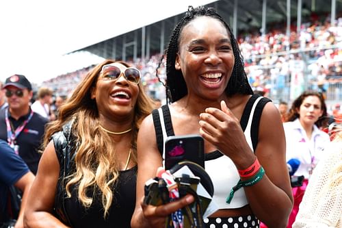 Three-time Olympic gold medalists together, Serena Williams (L) and Venus Williams at the Miami GP | via Getty Images