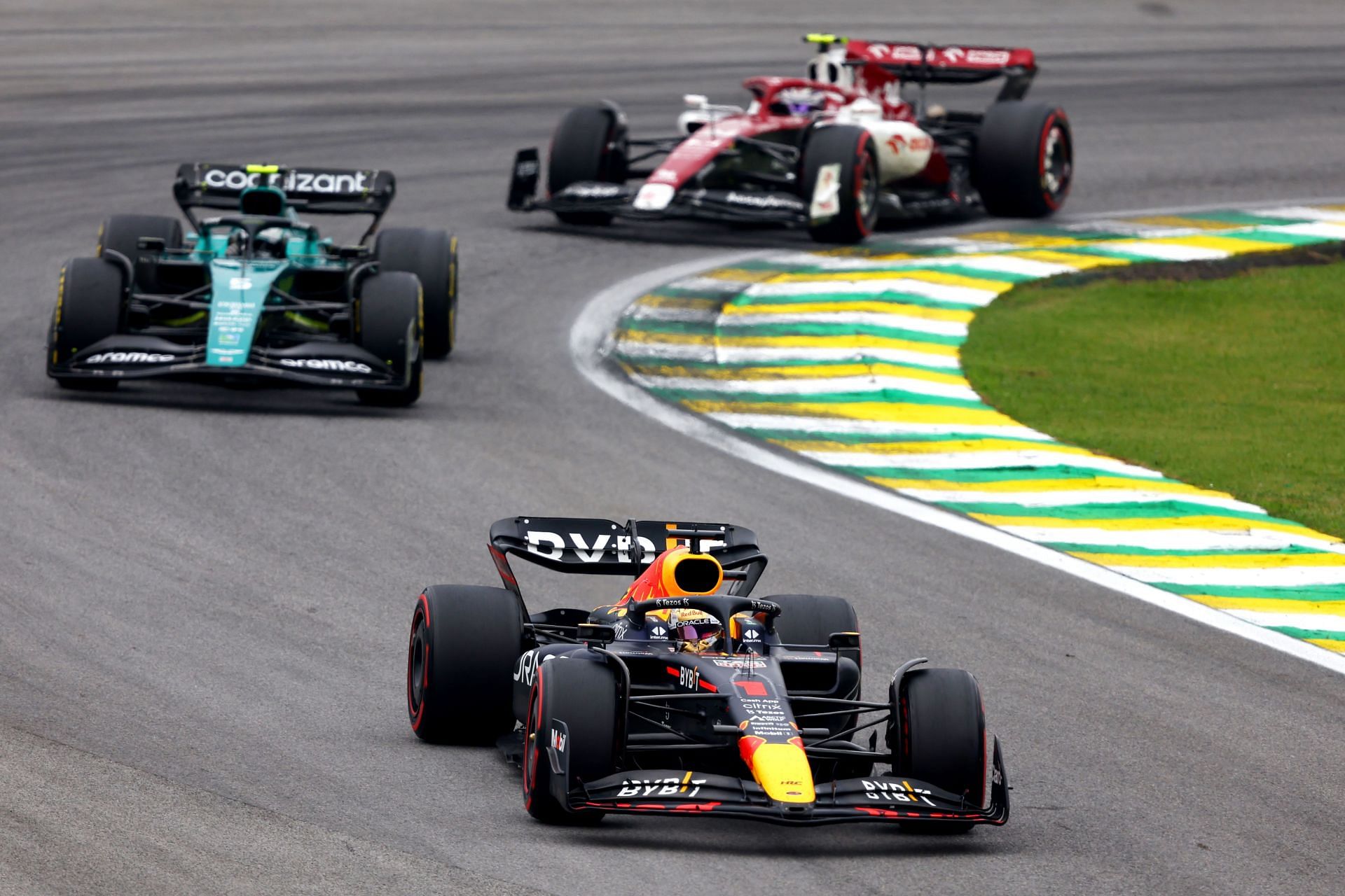 Max Verstappen of the Netherlands driving the (1) Oracle Red Bull Racing RB18 leads Sebastian Vettel of Germany driving the (5) Aston Martin AMR22 Mercedes and Zhou Guanyu on track during the F1 Grand Prix of Brazil | Getty Images