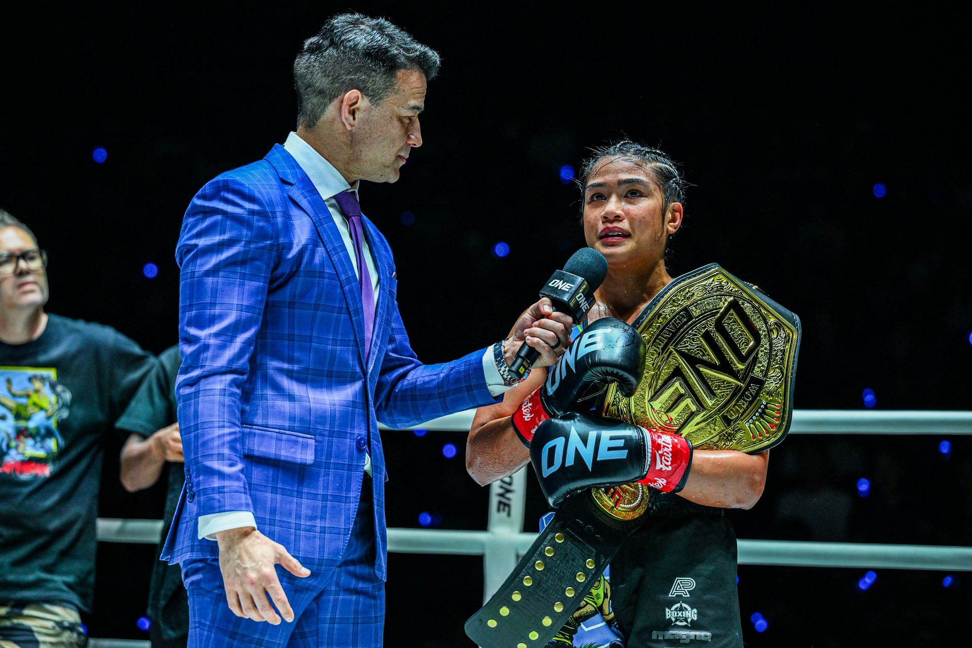 Jackie Buntan (right) speaks to Mitch Chilson shortly after her win at ONE 169.