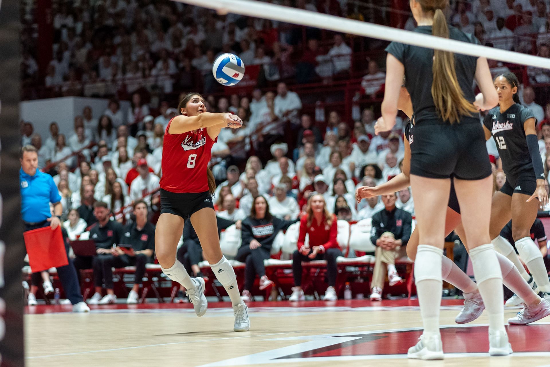 Rodriguez (in red) for Nebraska Cornhuskers during a match against Wisconsin (Image via: Getty Images)