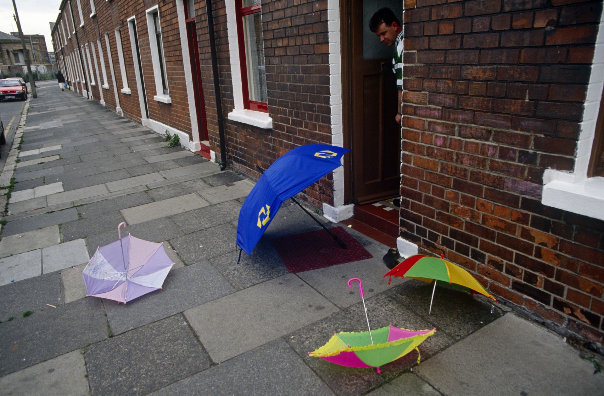 Northern Ireland - Belfast - Umbrellas on terraced street pavement (Image via Getty)