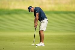 Bryson DeChambeau stands on the roadside holding a sign to spread an important message