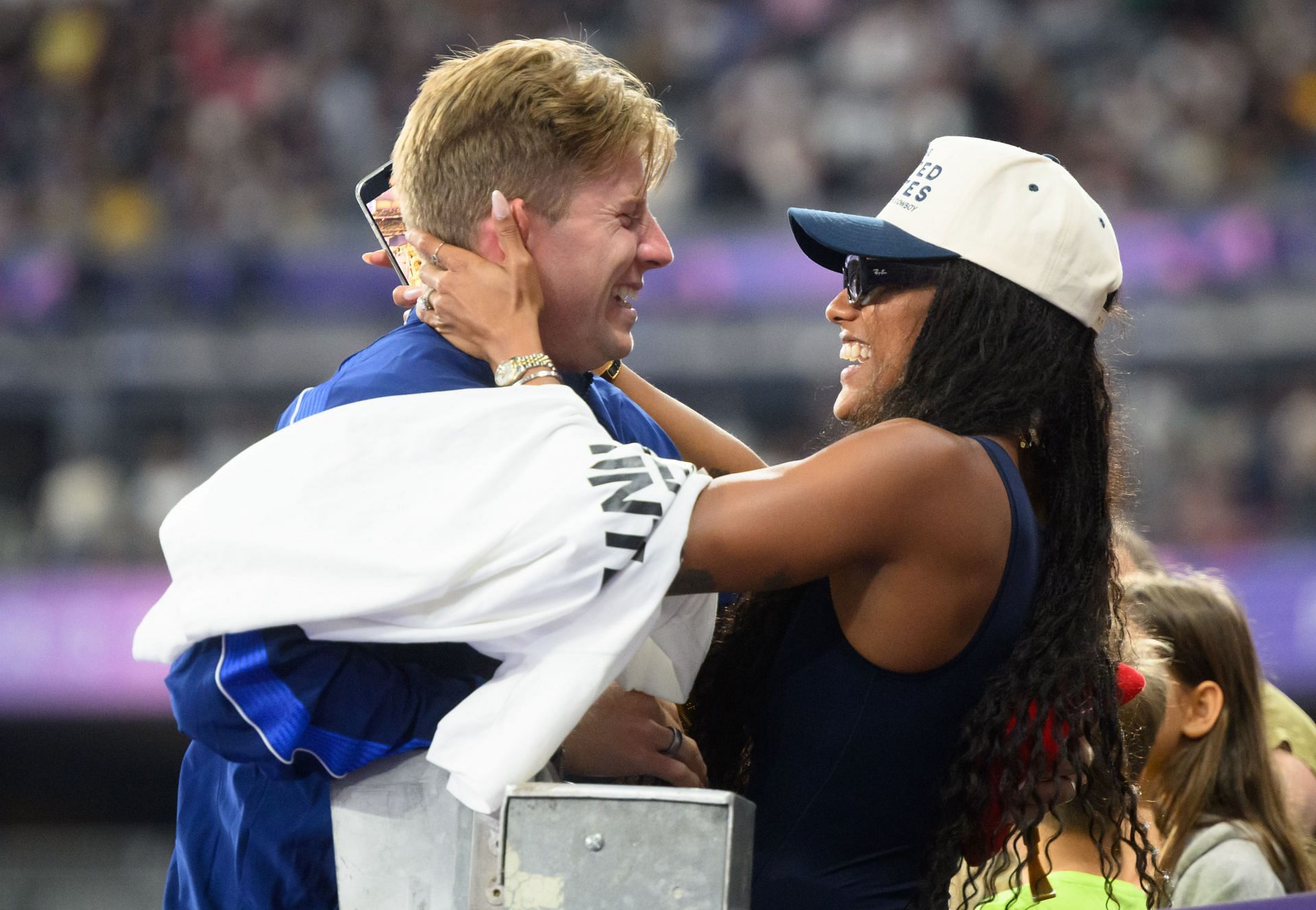 Tara Davis-Woodhall and Hunter Woodhall embracing each other at the Paris 2024 Paralympics; (Source: Getty)