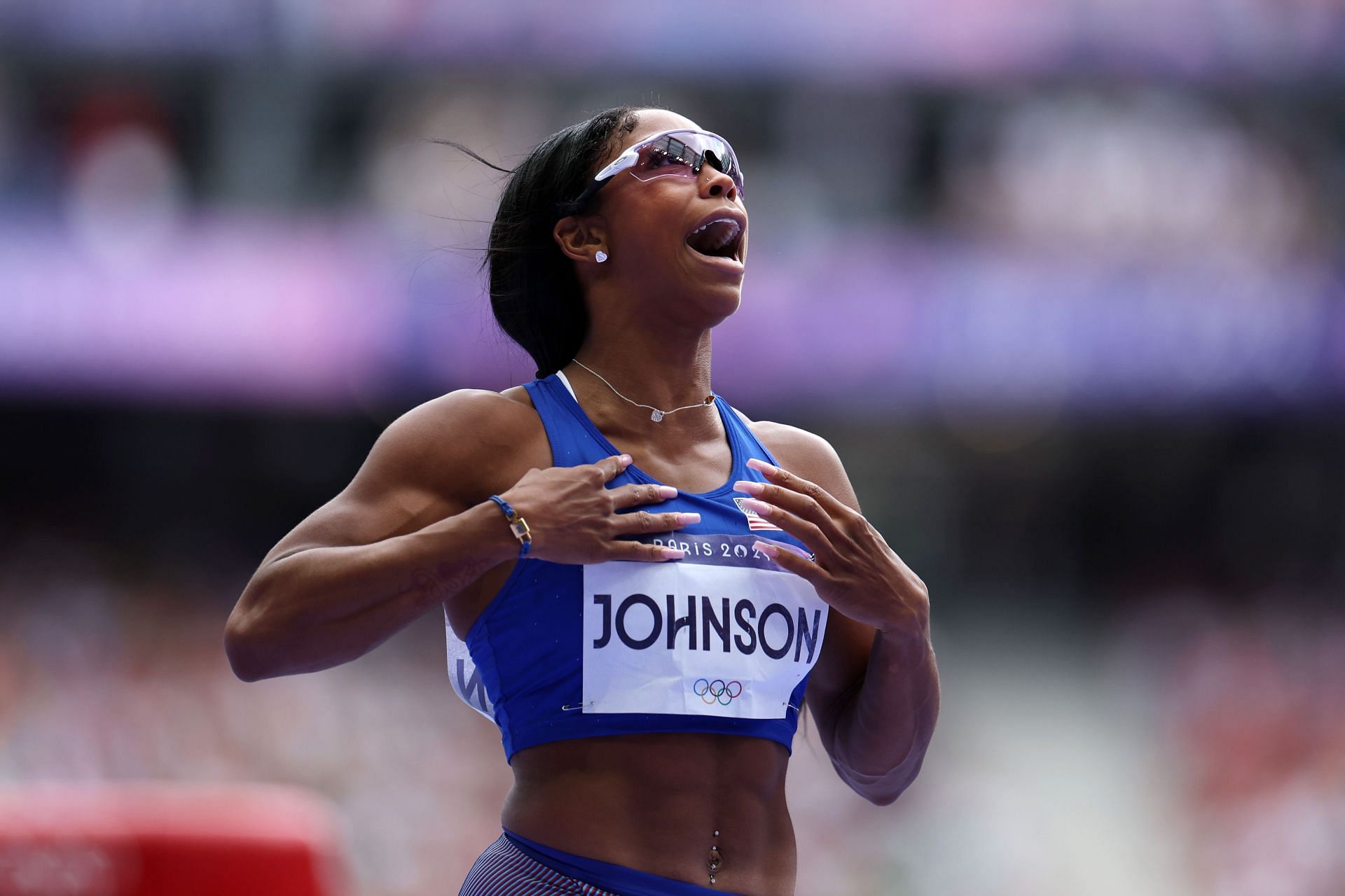 Johnson in blue track and field dress after qualifying for the finals of Women&#039;s 100m hurdles during the 2024 Summer Olympics (Image via: Getty Images)