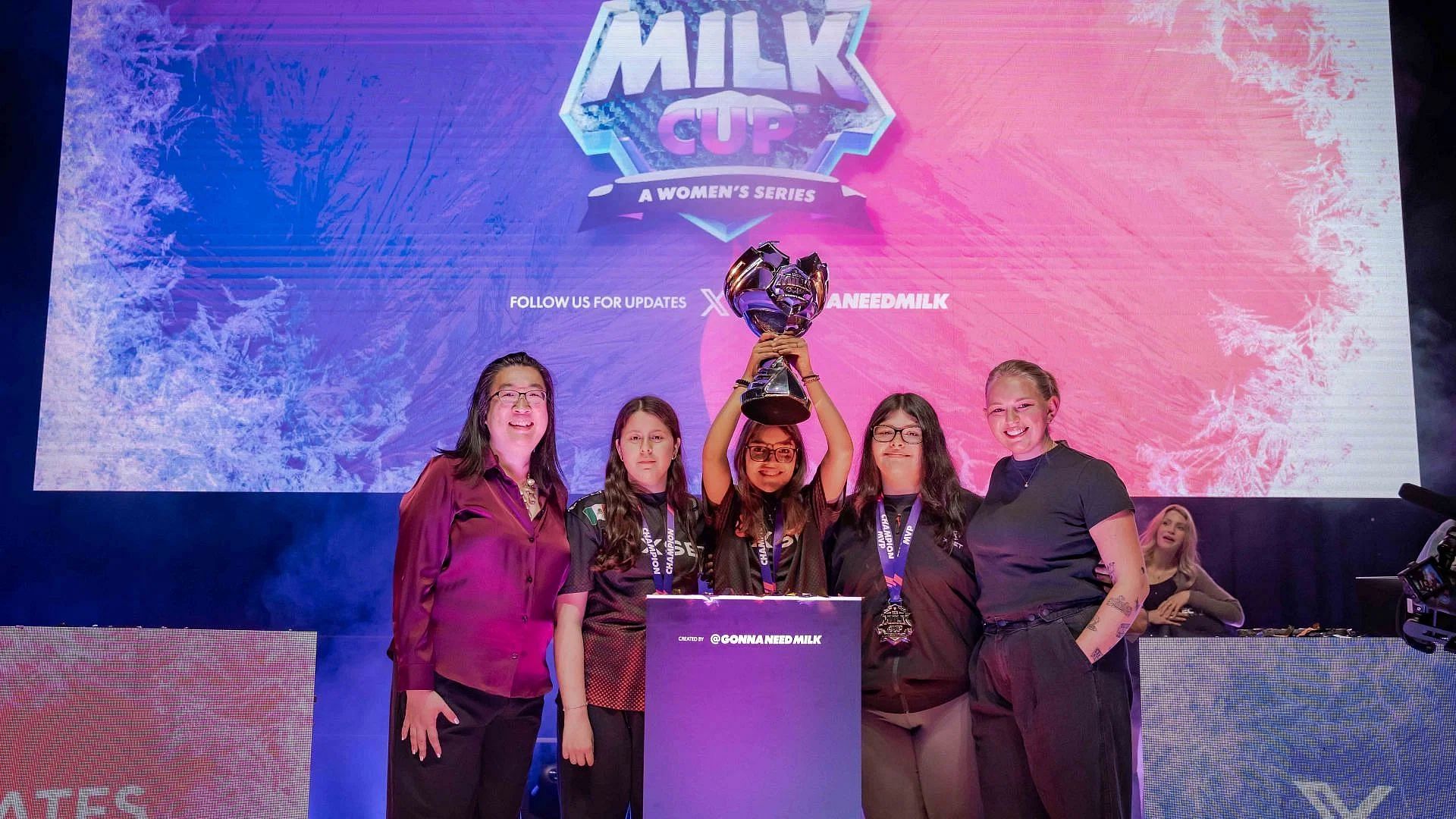 Team Moxie lifts the trophy with Yin Woon Rani and Jen Grubb (Image via The Milk Cup)