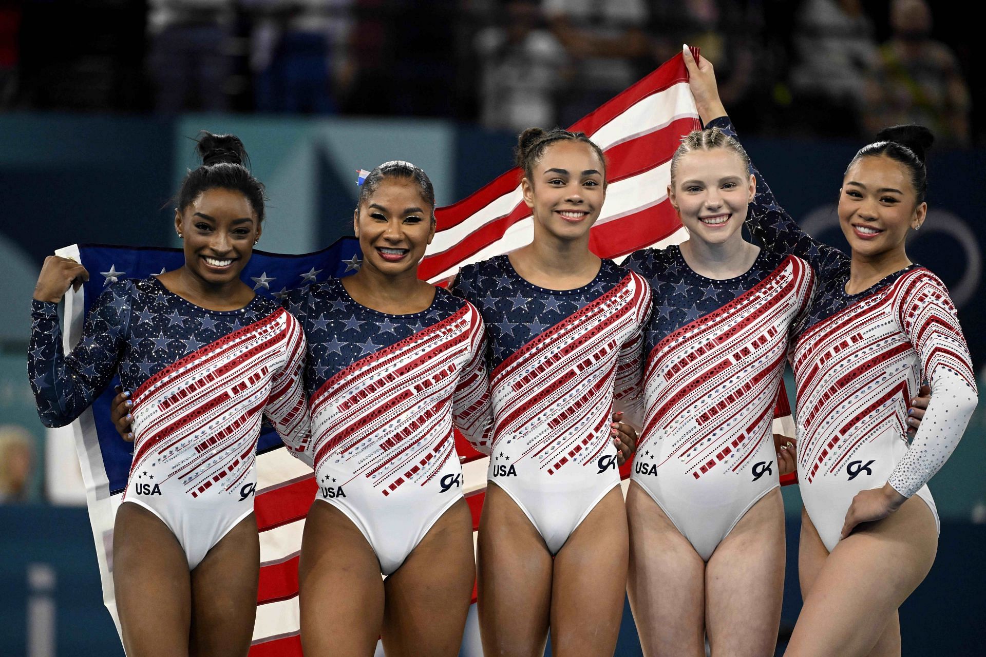 Simone Biles, Jordan Chiles, Hezly Rivera, Jade Carey and Sunisa Lee of the United States after winning the gold medal during the gymnastics team competition at the 2024 Olympic Games in Paris, France.(Photo via Getty Images)