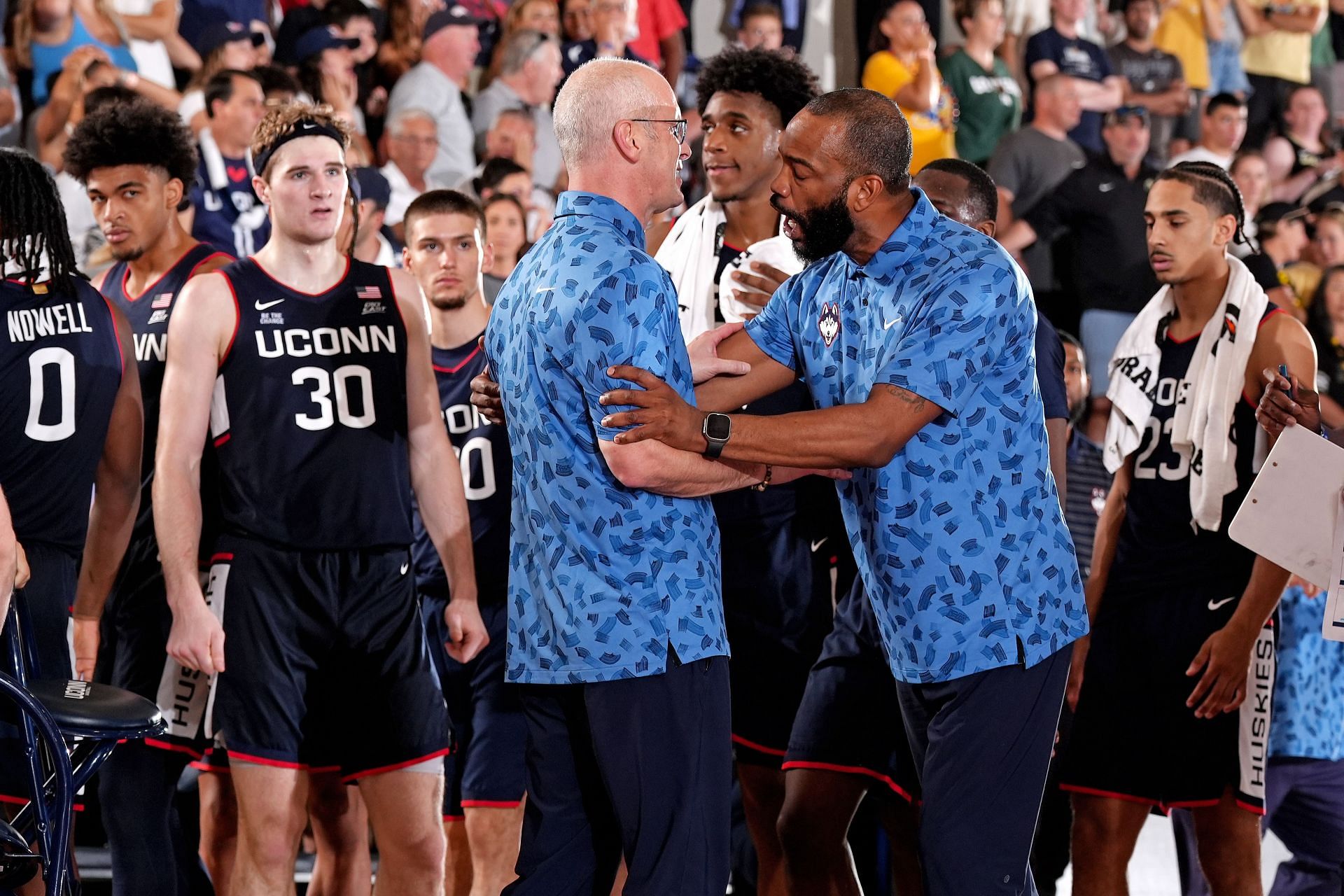 UConn Huskies coach Dan Hurley is restrained by an assistant coach during their game against the Colorado Buffaloes in Maui, Hawaii (Image Source: Getty)