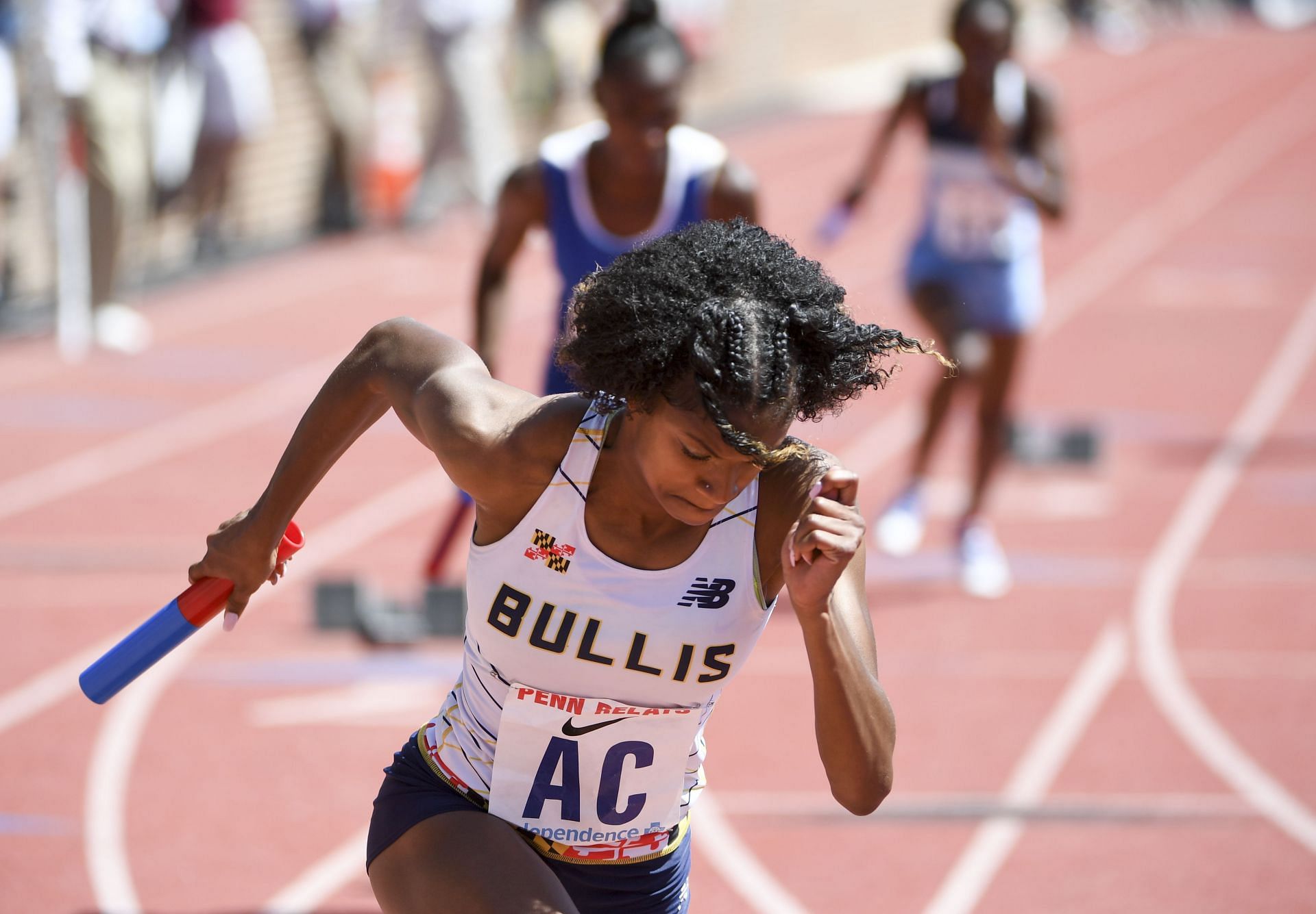 Russell competing for the Bullis School in a white track uniform at the 123rd Penn Relays (Image via Getty Images)