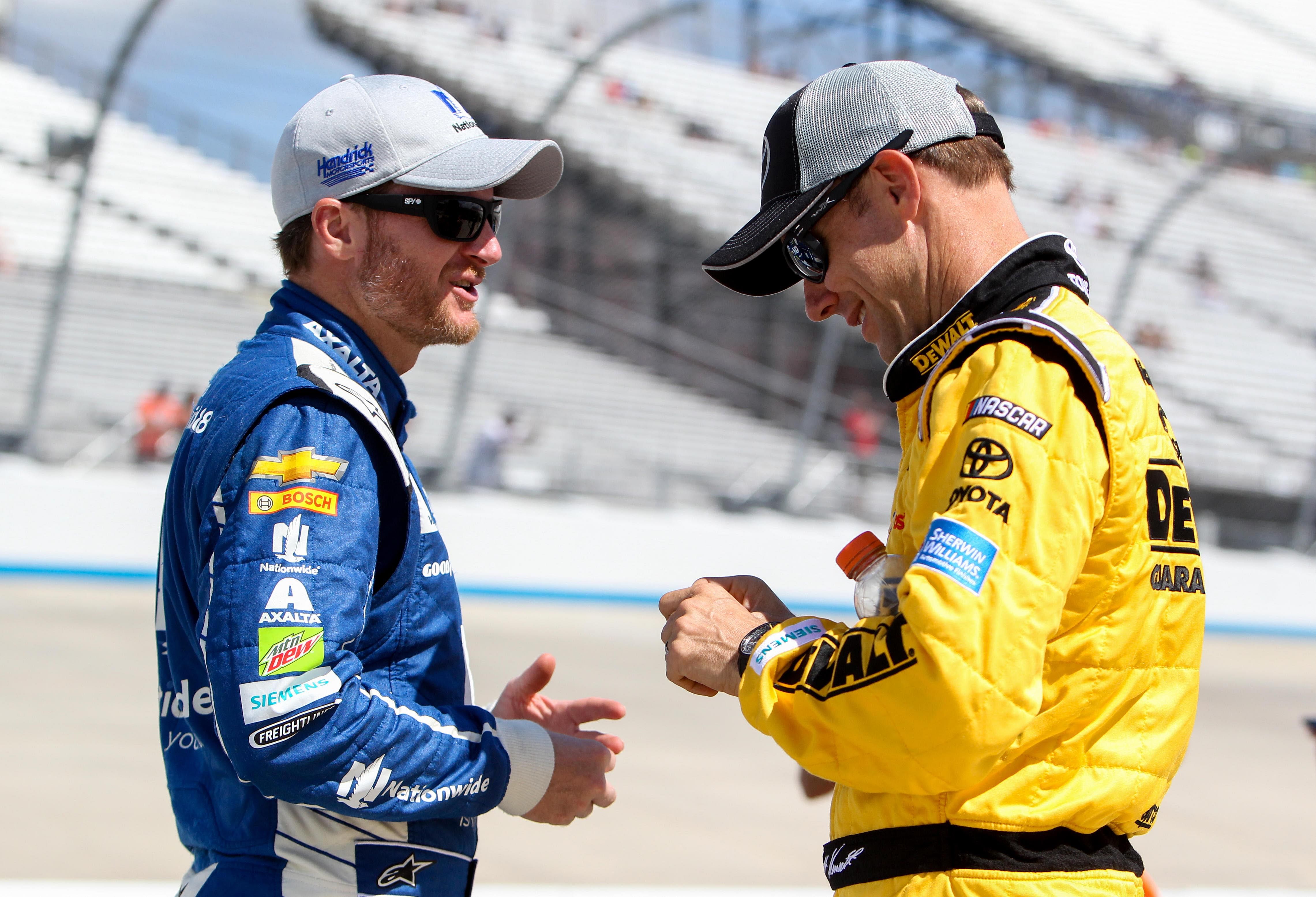 Dale Earnhardt Jr (left) chats with Matt Kenseth (right) on pit road during the qualifying for the AAA 400 Drive For Autism at Dover International Speedway. (Image Source: Imagn)