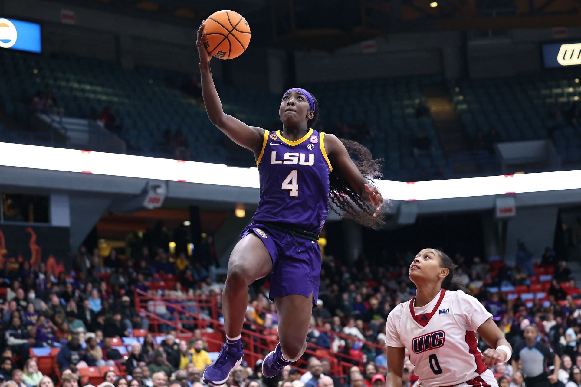 Flau&#039;Jae Johnson #4 of the LSU Tigers scores a layup during a game. (Credits: Getty)