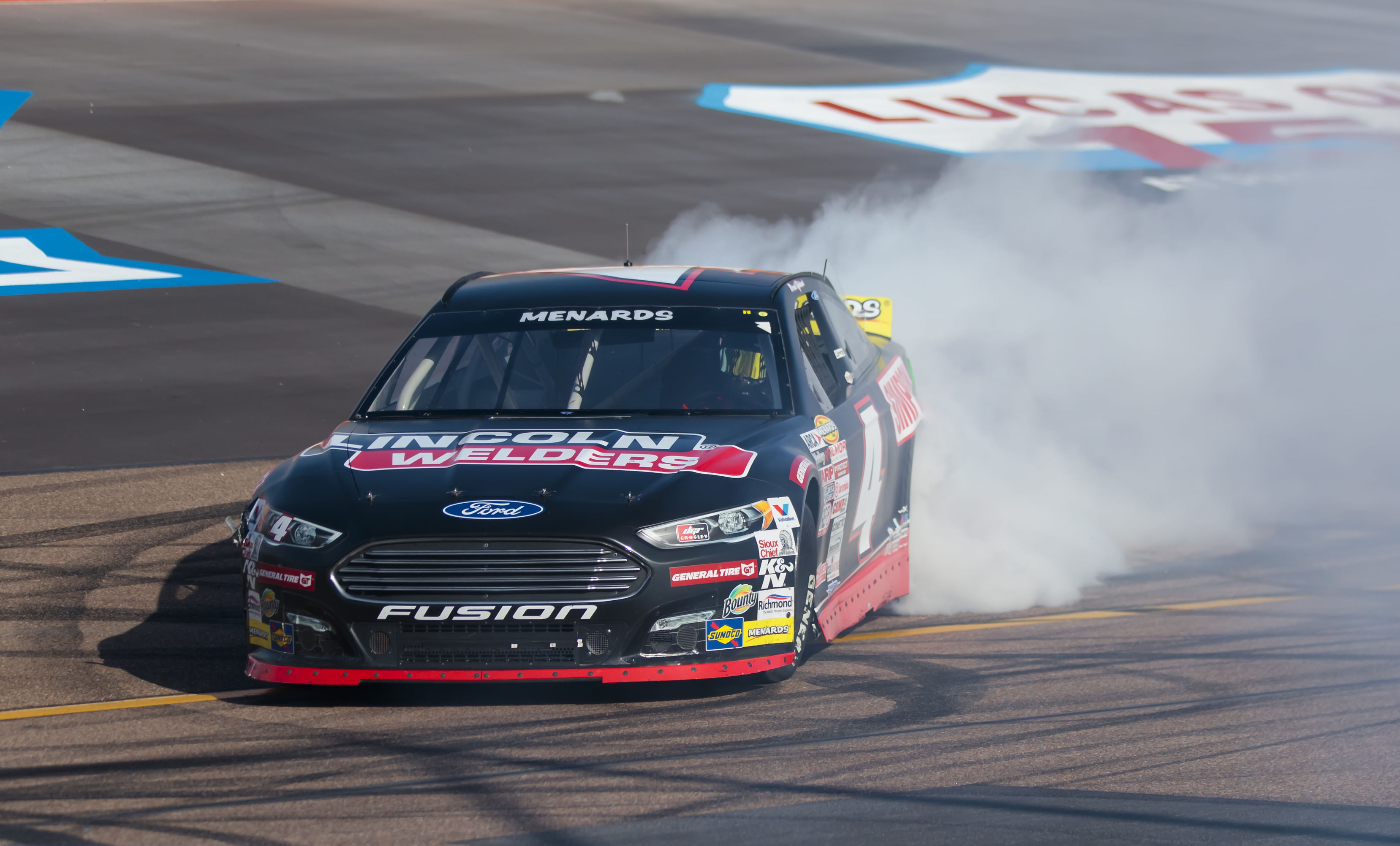 David Gilliland celebrates with a burnout after winning the Arizona Lottery 100 at Phoenix Raceway (Image via Imagn)