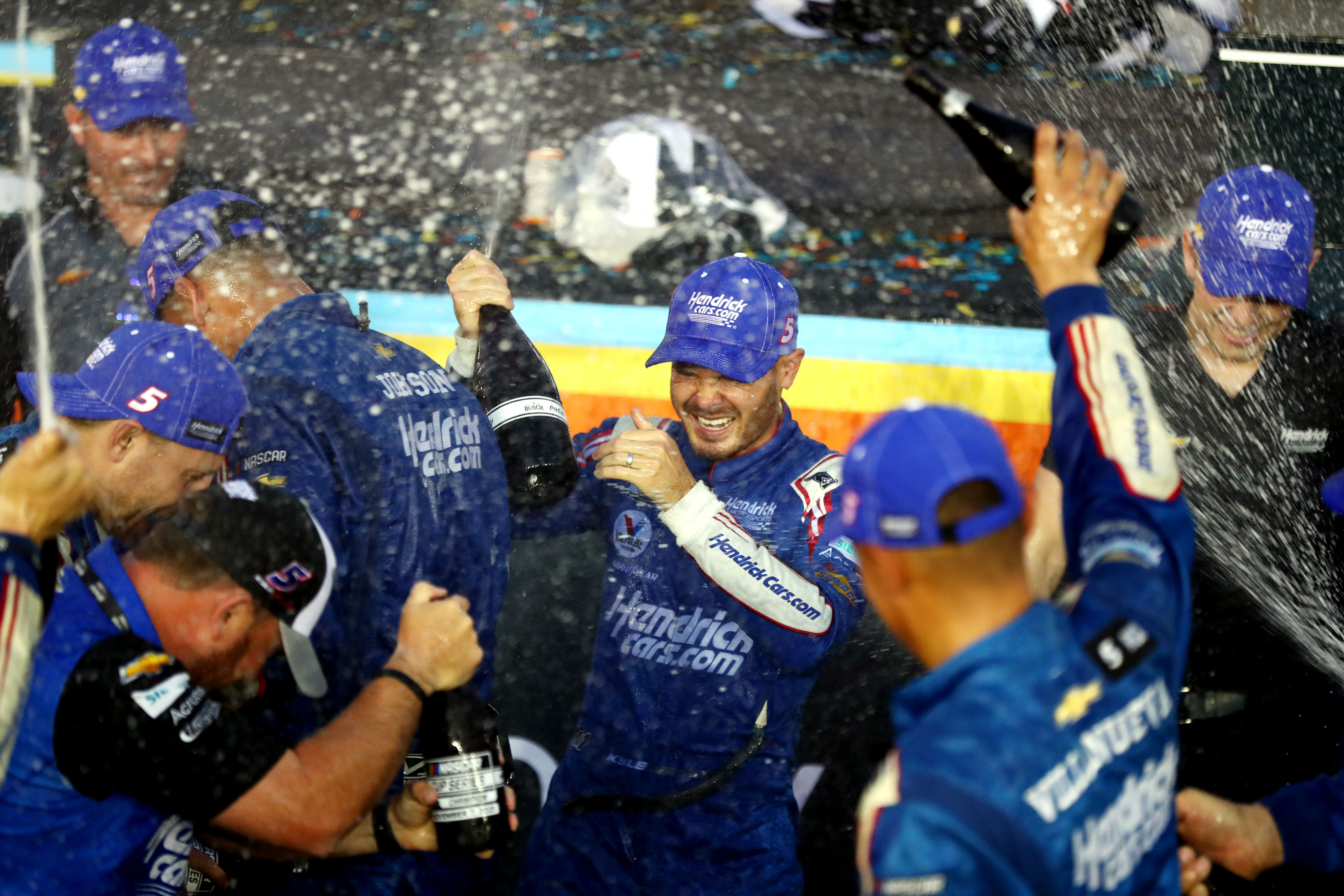 Kyle Larson (5) sprays champagne as the team celebrates in victory lane after winning the NASCAR Cup Series Championship at Phoenix Raceway. Mandatory Credit:- Imagn Images