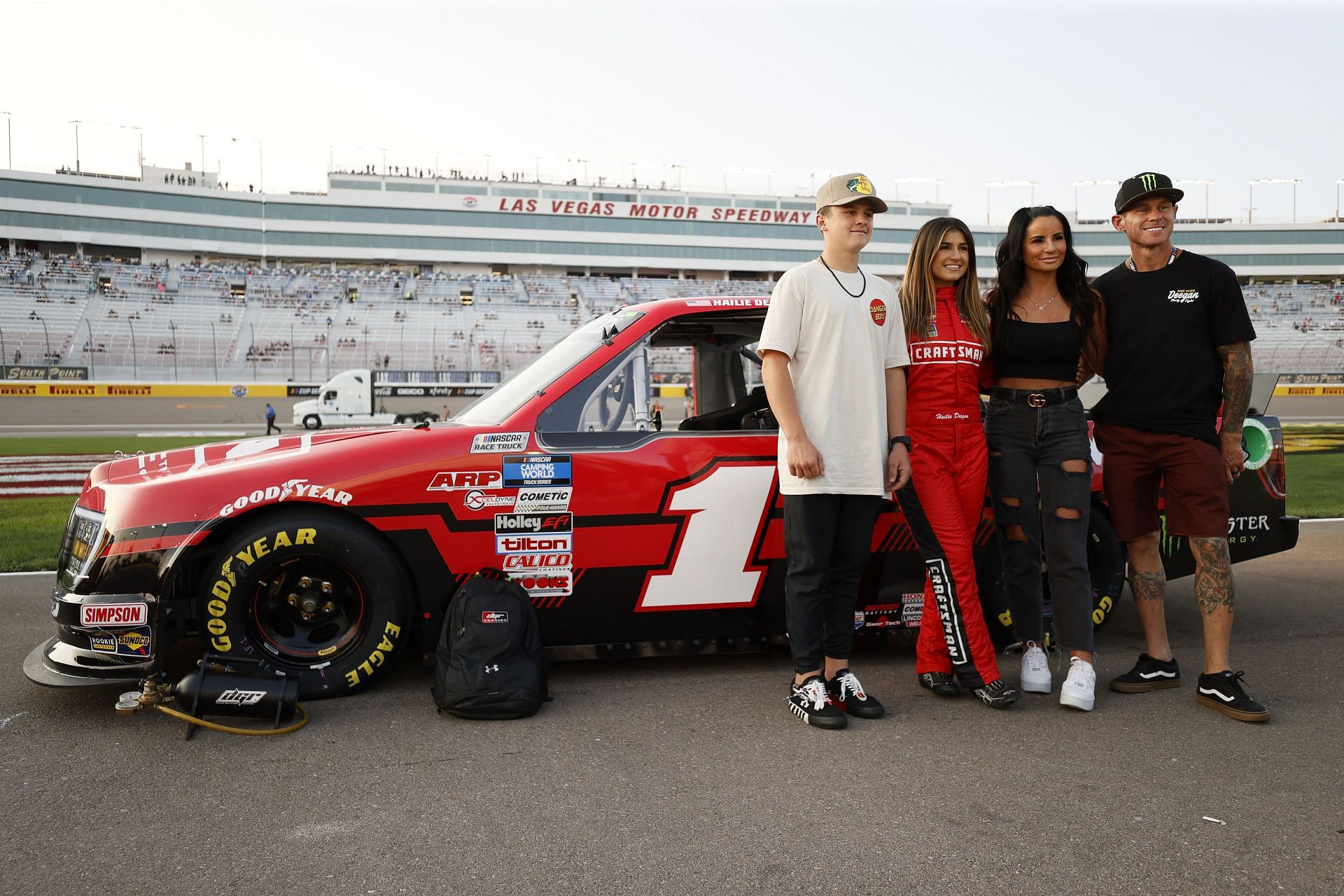 Hailie Deegan poses on the grid with her mother, Marissa Deegan, and father, and professional freestyle motocross rider, Brian Deegan, and brother Haiden Deegan - Source: Getty