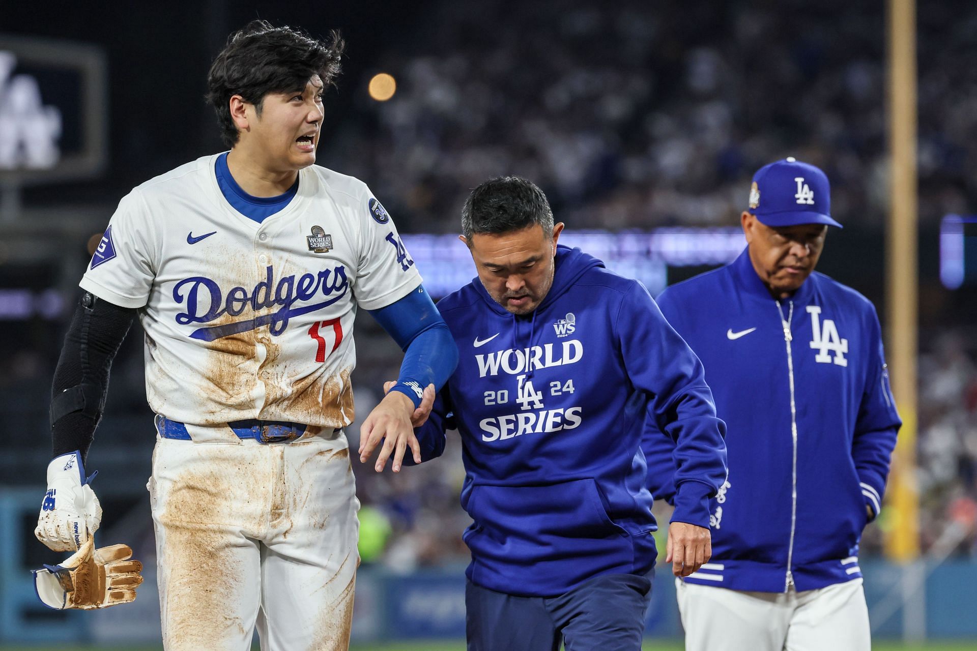 Shohei Ohtani walks off the field after injuring his shoulder in game two of the World Series against the New York Yankees. (Credits: Getty)