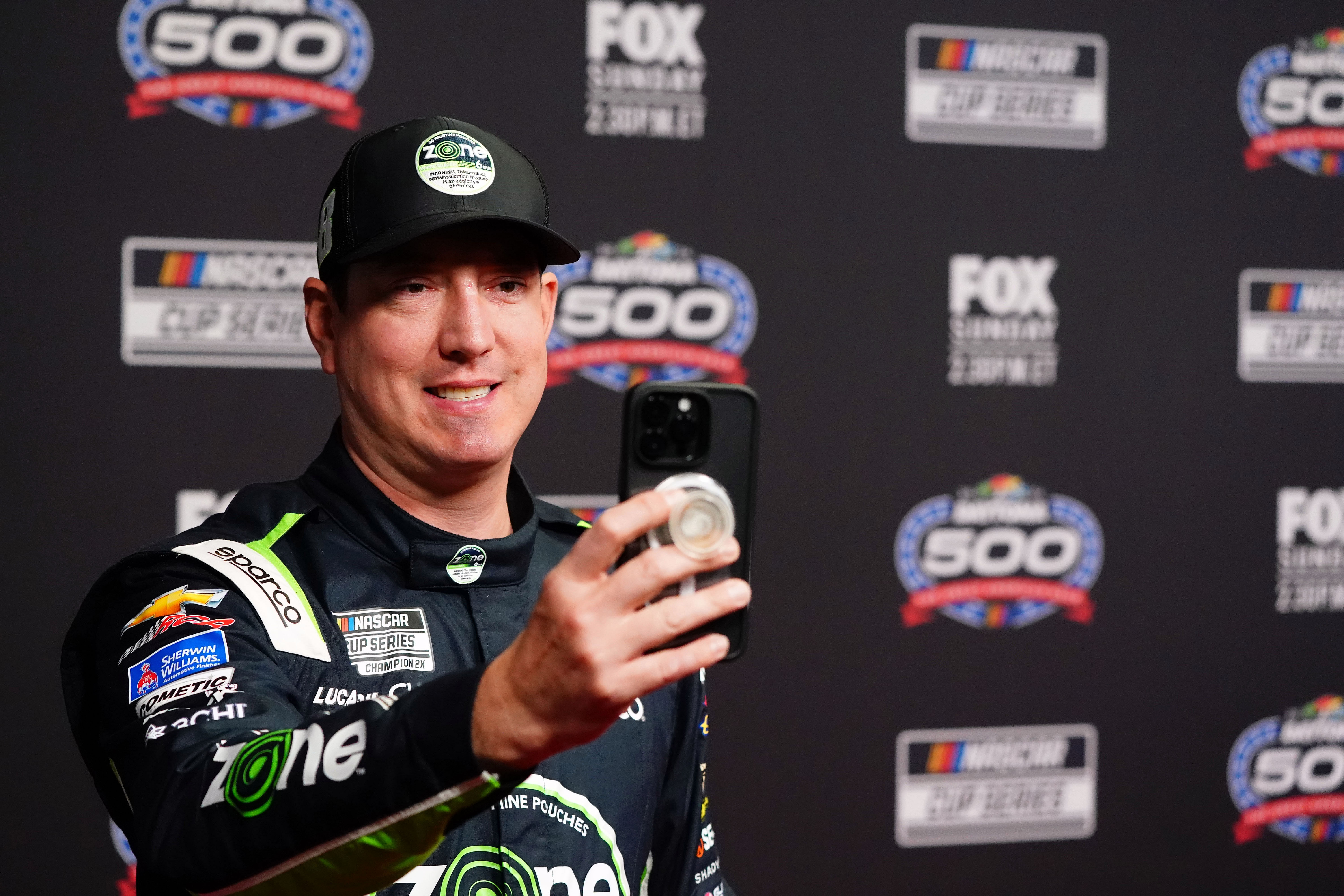 Cup Series driver Kyle Busch does a social media post during media day at Daytona International Speedway. - Source: Imagn