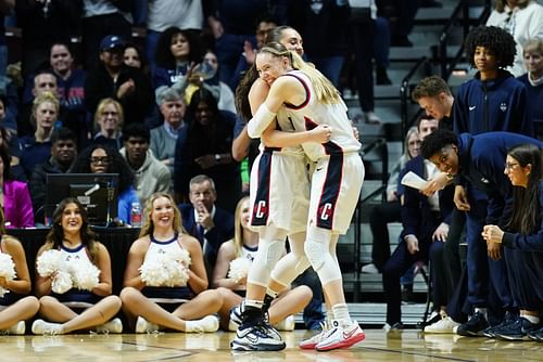 UConn Huskies guard Paige Bueckers, right, hugs guard Nika Muhl late in the fourth quarter against the Georgetown Hoyas at Mohegan Sun Arena. Photo: Imagn