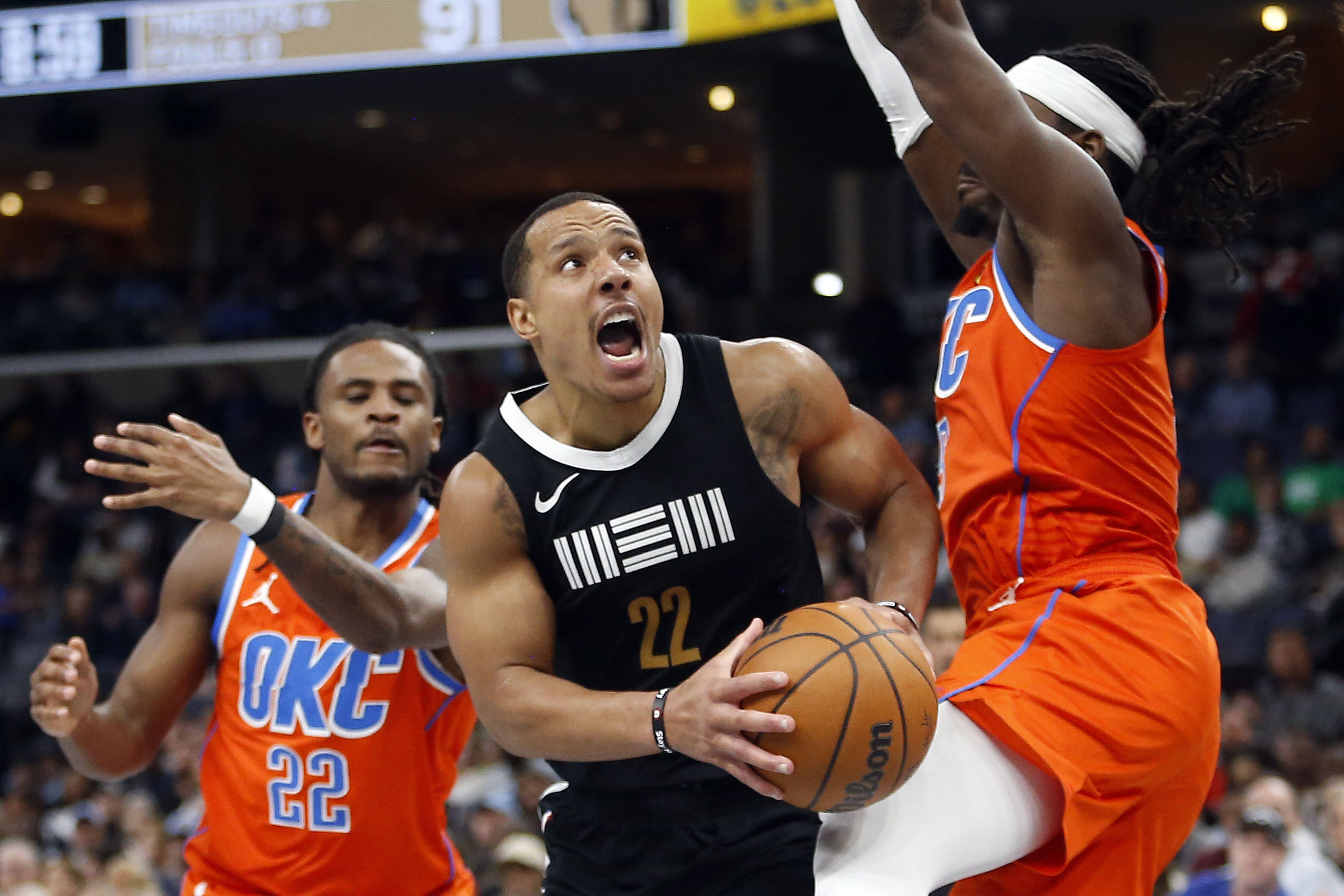 Mar 16, 2024; Memphis, Tennessee, USA; Memphis Grizzlies guard Desmond Bane (22) drives to the basket as Oklahoma City Thunder guard Luguentz Dort (5) defends during the second half at FedExForum. Mandatory Credit: Petre Thomas-Imagn Images - Source: Imagn