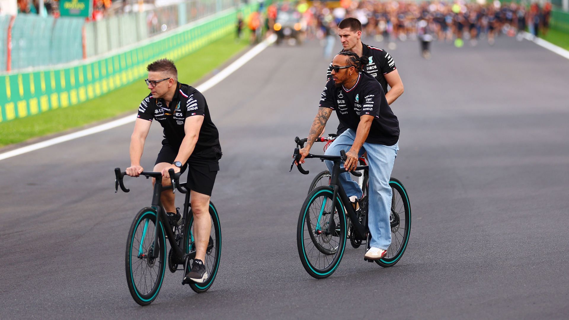 Britain's Lewis Hamilton and Mercedes cycle on the track with race engineer Peter Bonnington - Source: Getty Images