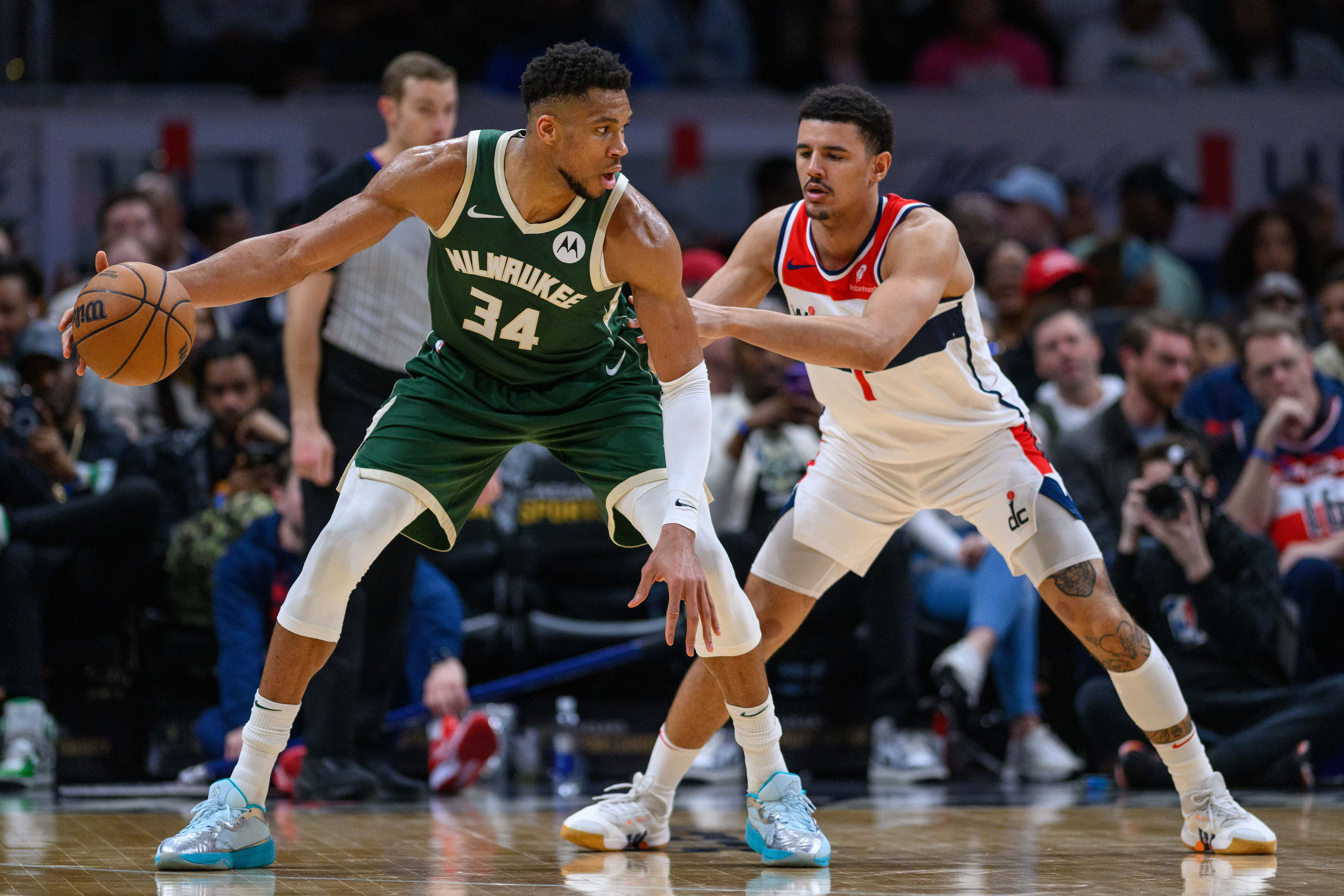 Milwaukee Bucks forward Giannis Antetokounmpo (34) dribbles while being defended by Washington Wizards guard Johnny Davis (1) during the third quarter at Capital One Arena. Mandatory Credit: Reggie Hildred-Imagn Images