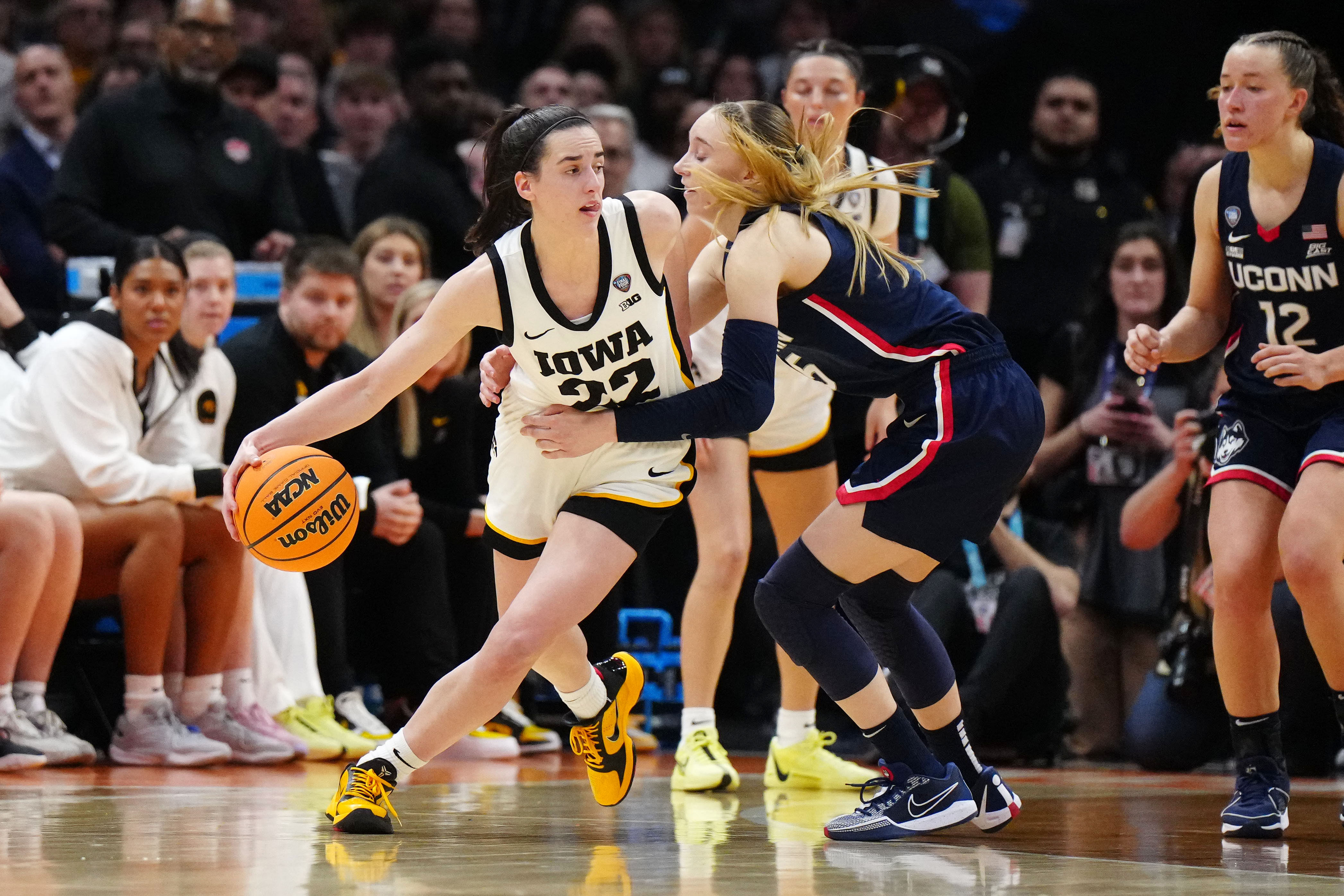 Iowa Hawkeyes guard Caitlin Clark (22) controls the ball against Connecticut Huskies guard Paige Bueckers (5) in the fourth quarter in the semifinals of the Final Four of the womens 2024 NCAA Tournament - Source: Imagn