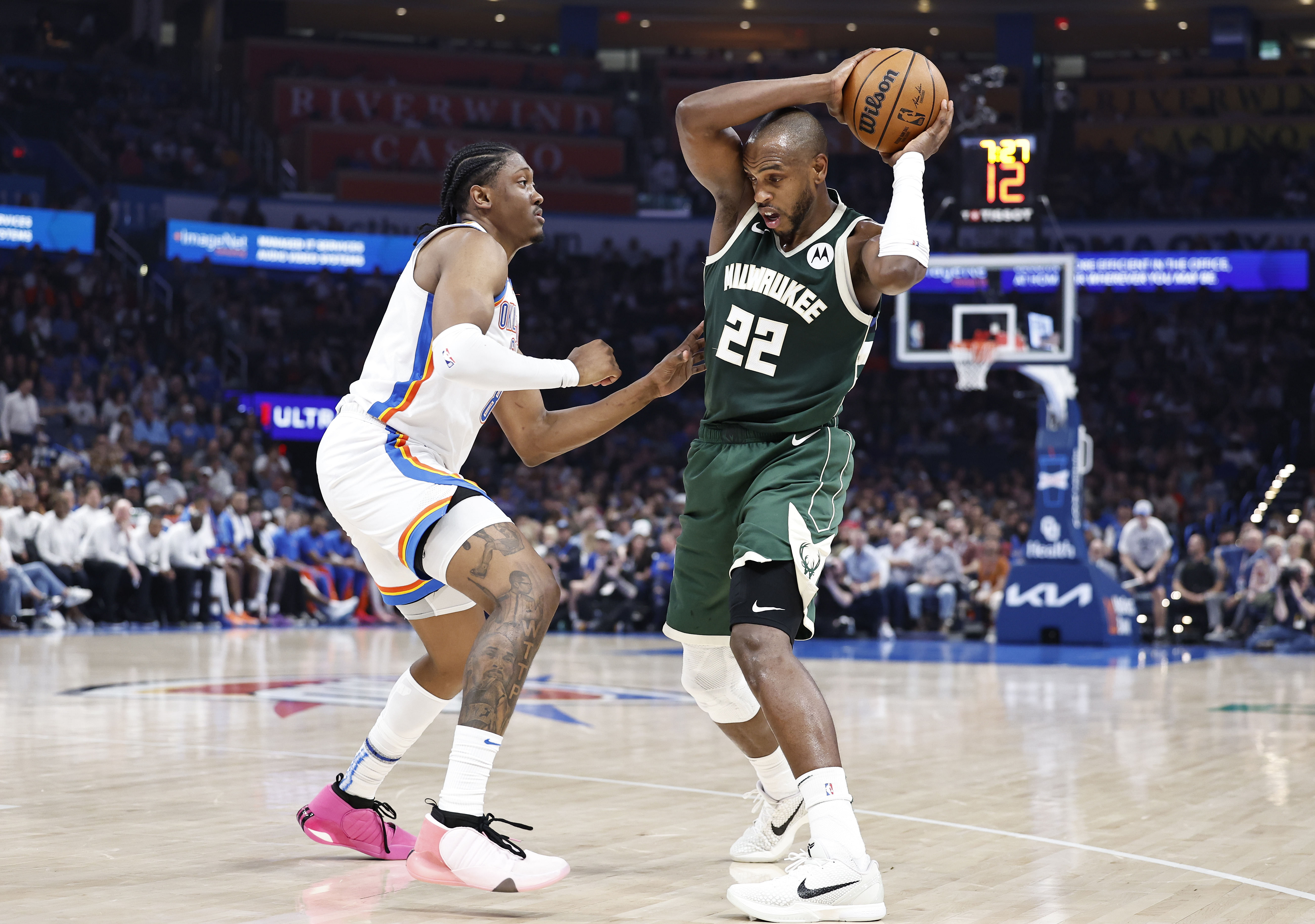 Milwaukee Bucks forward Khris Middleton (22) works to keep the ball away from Oklahoma City Thunder forward Jalen Williams (8) - Source: Imagn