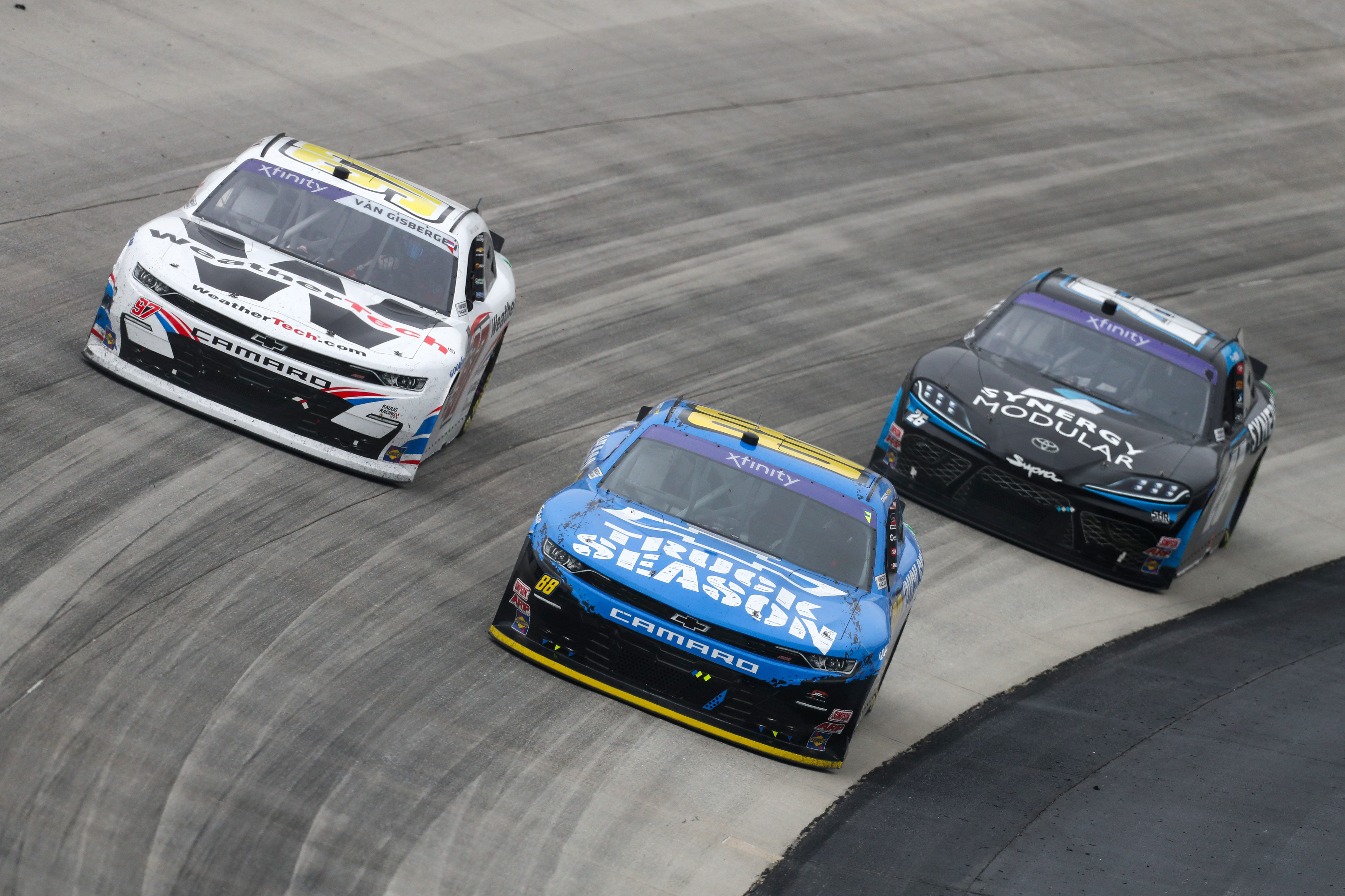 Carson Kvapil (88) races to the inside of driver Shane Van Gisbergen (97) during the BetRivers 200 at Dover Motor Speedway. - Source: Imagn