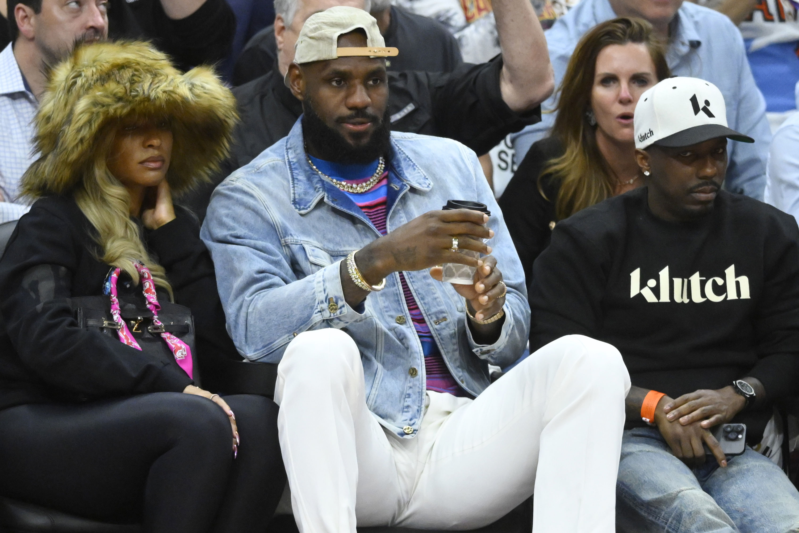 May 13, 2024; Cleveland, Ohio, USA; Savannah James, LeBron James and Rich Paul sit in the front in the fourth quarter of game four of the second round for the 2024 NBA playoffs between the Cleveland Cavaliers and the Boston Celtics at Rocket Mortgage FieldHouse. Mandatory Credit: David Richard-Imagn Images - Source: Imagn