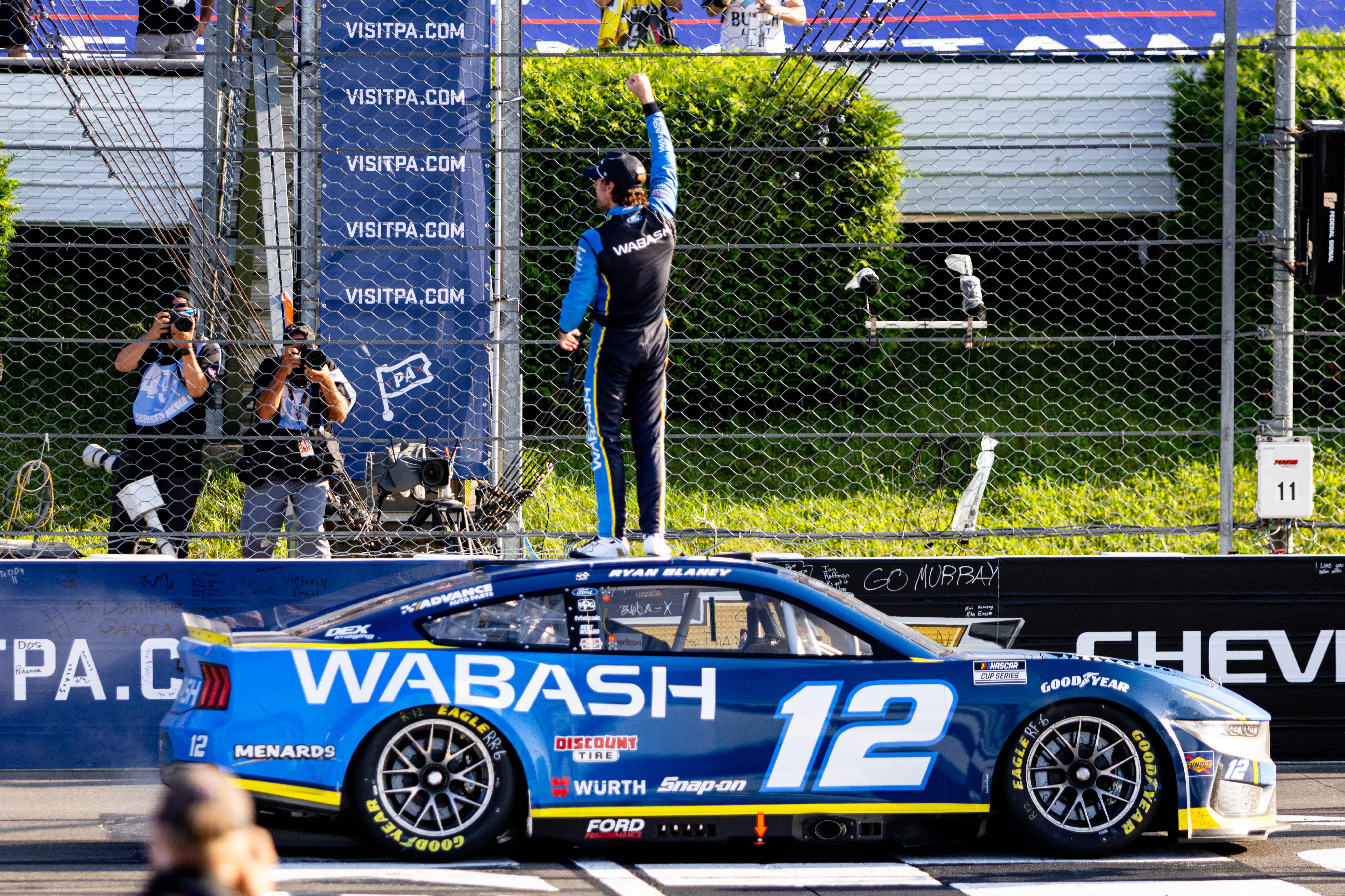 Ryan Blaney sets onto his car to show off his win to the fans at the Pocono Raceway on July 14, 2024 - Source: Imagn