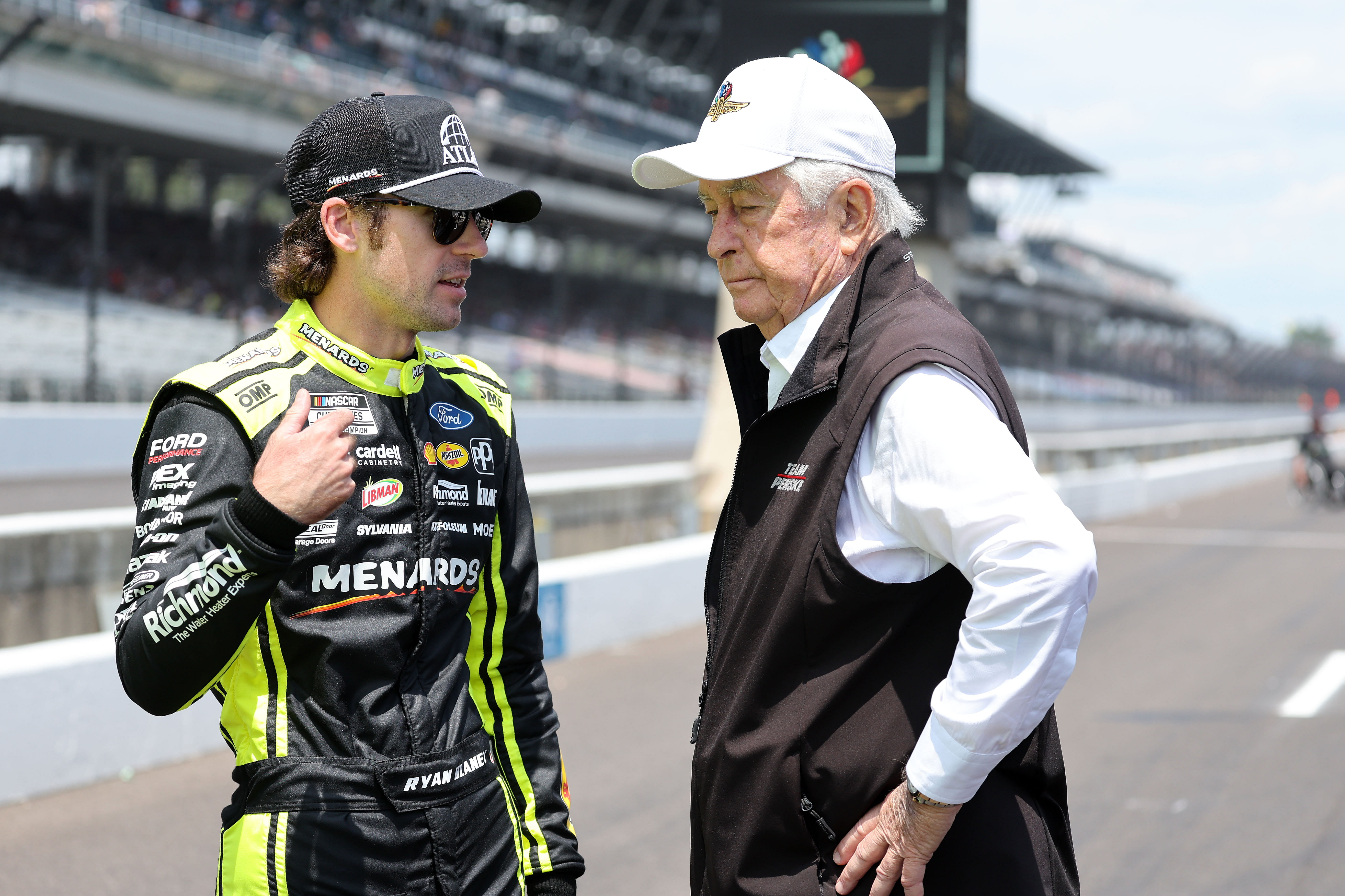 NASCAR Cup Series driver Ryan Blaney (12) and team owner Roger Penske talk during qualifying for the Brickyard 400 at Indianapolis Motor Speedway. Mandatory Credit: Mike Dinovo-Imagn Images