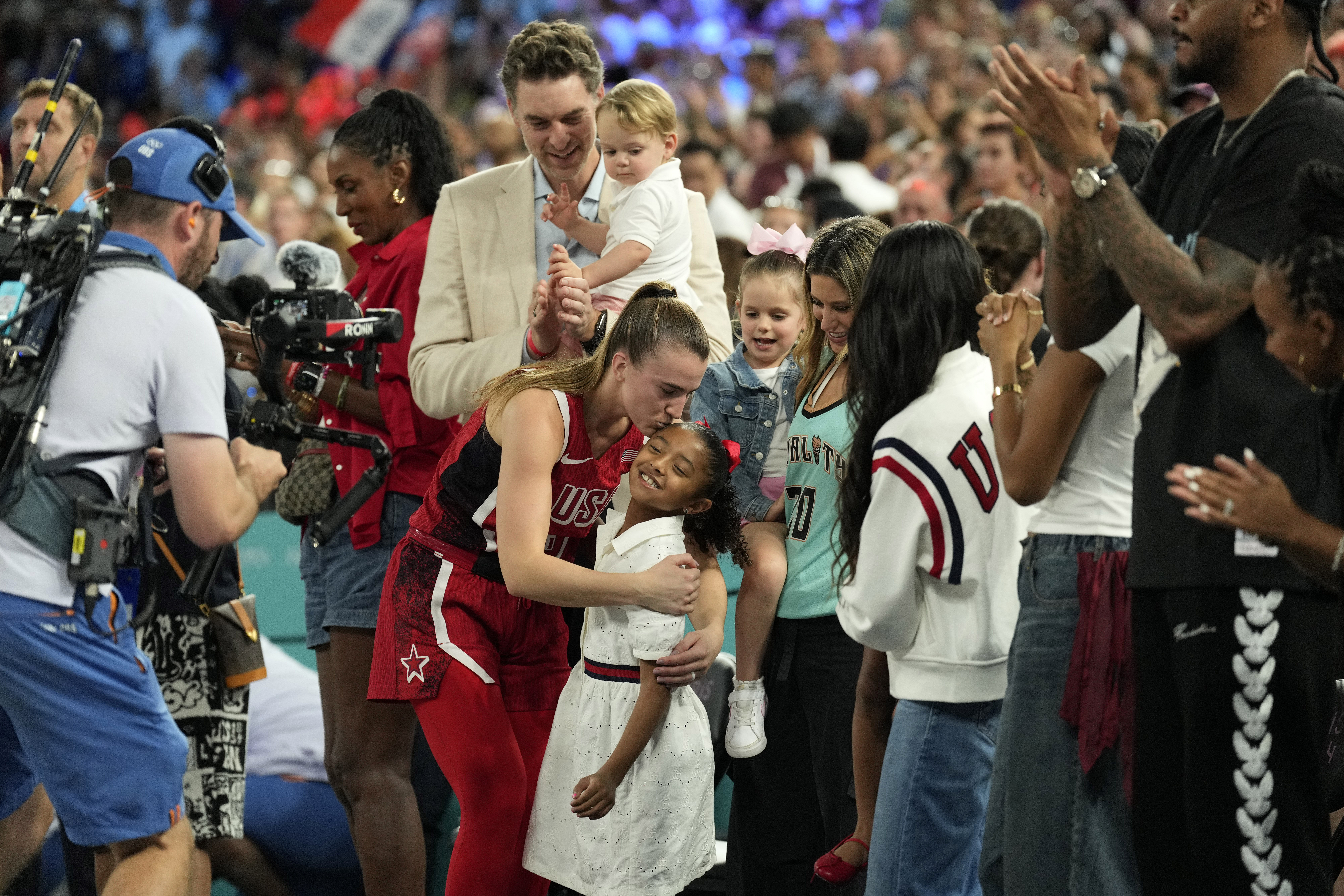 United States guard Sabrina Ionescu celebrates with the family of Vanessa Bryant after defeating France at the Paris 2024 Olympic Summer Games. Photo Credit: Imagn