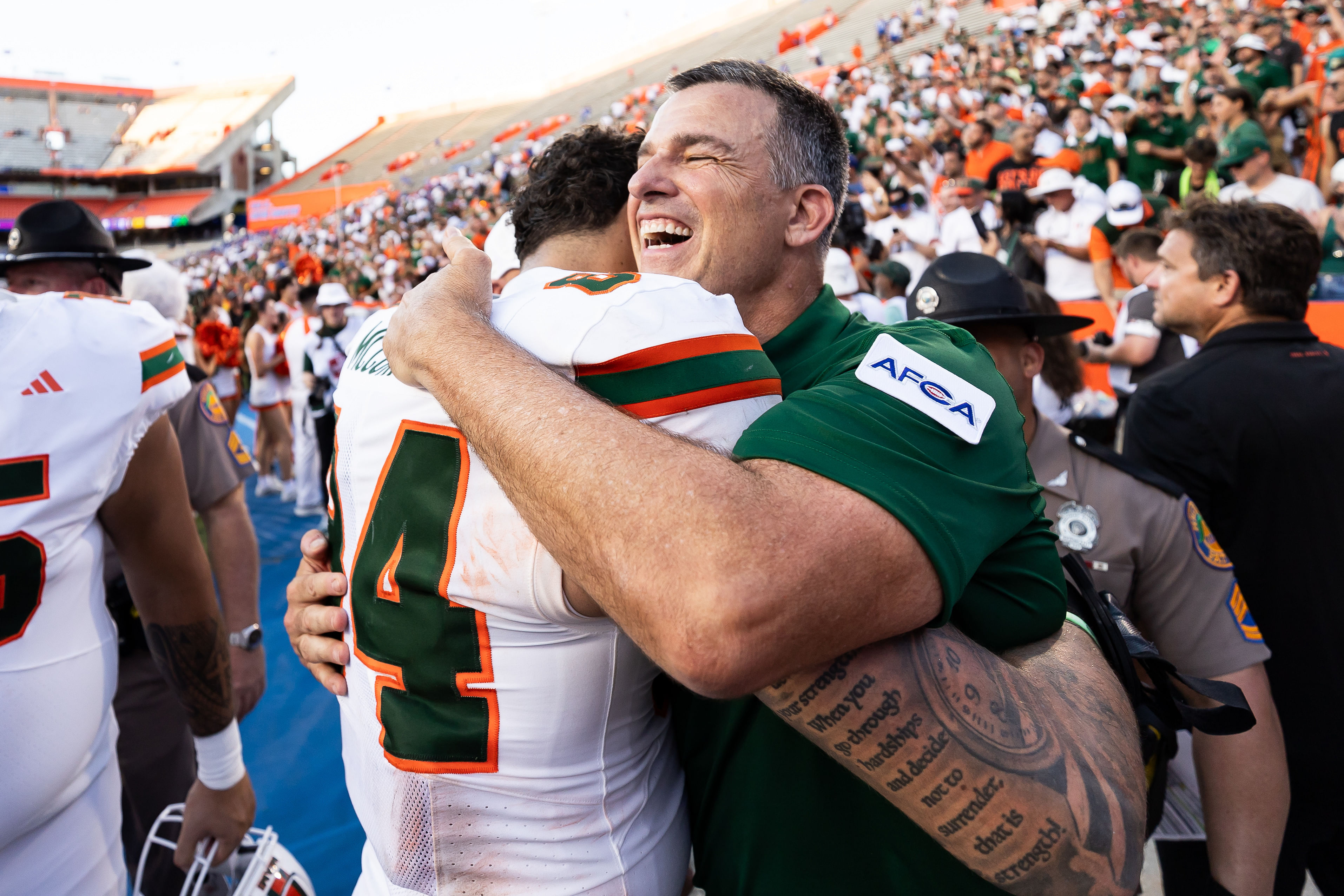 Miami Hurricanes head coach Mario Cristobal hugs tight end Cam McCormick (Image Source: Imagn)