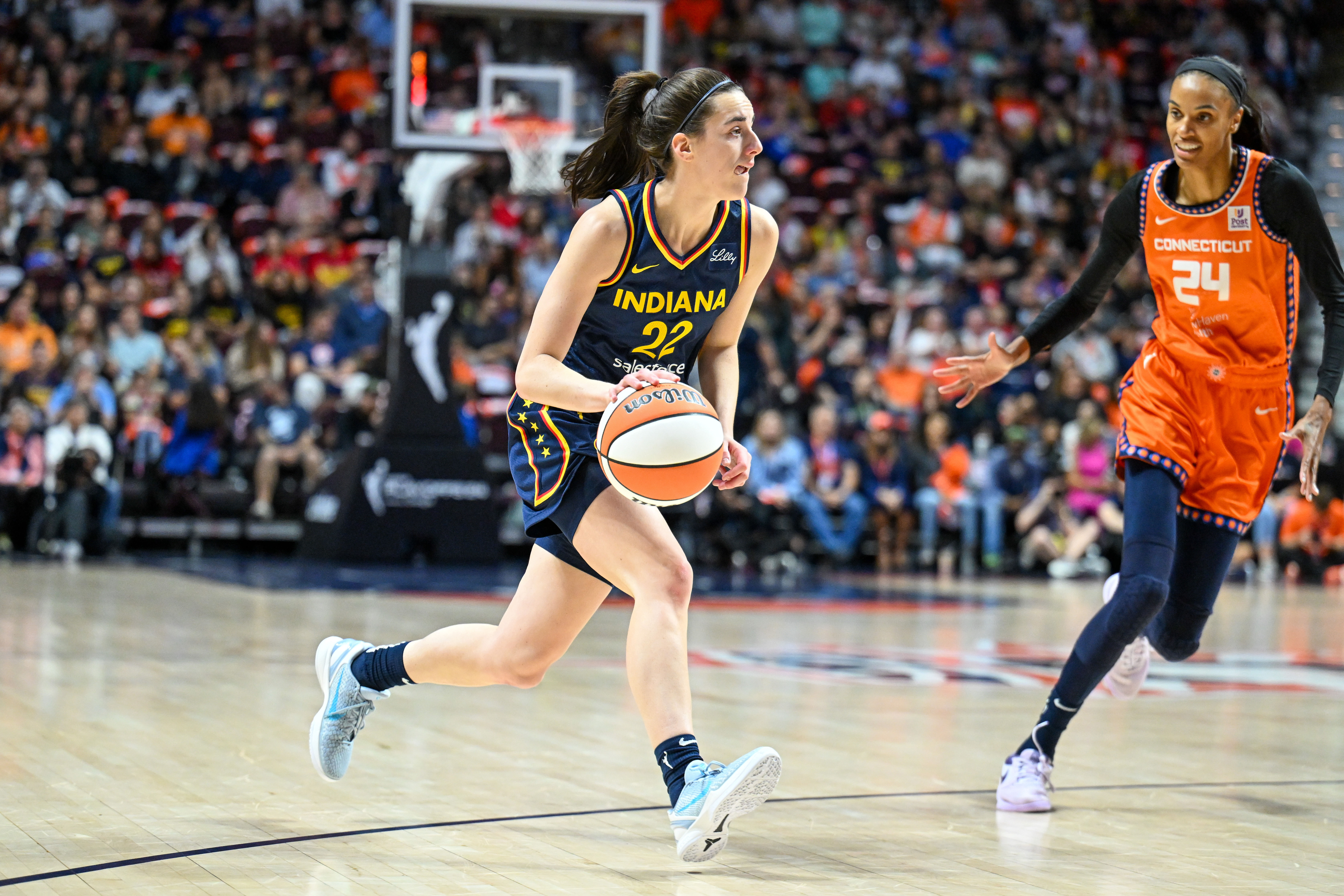 Indiana Fever guard Caitlin Clark dribbles the ball against the Connecticut Sun at Mohegan Sun Arena. Photo Credit: Imagn