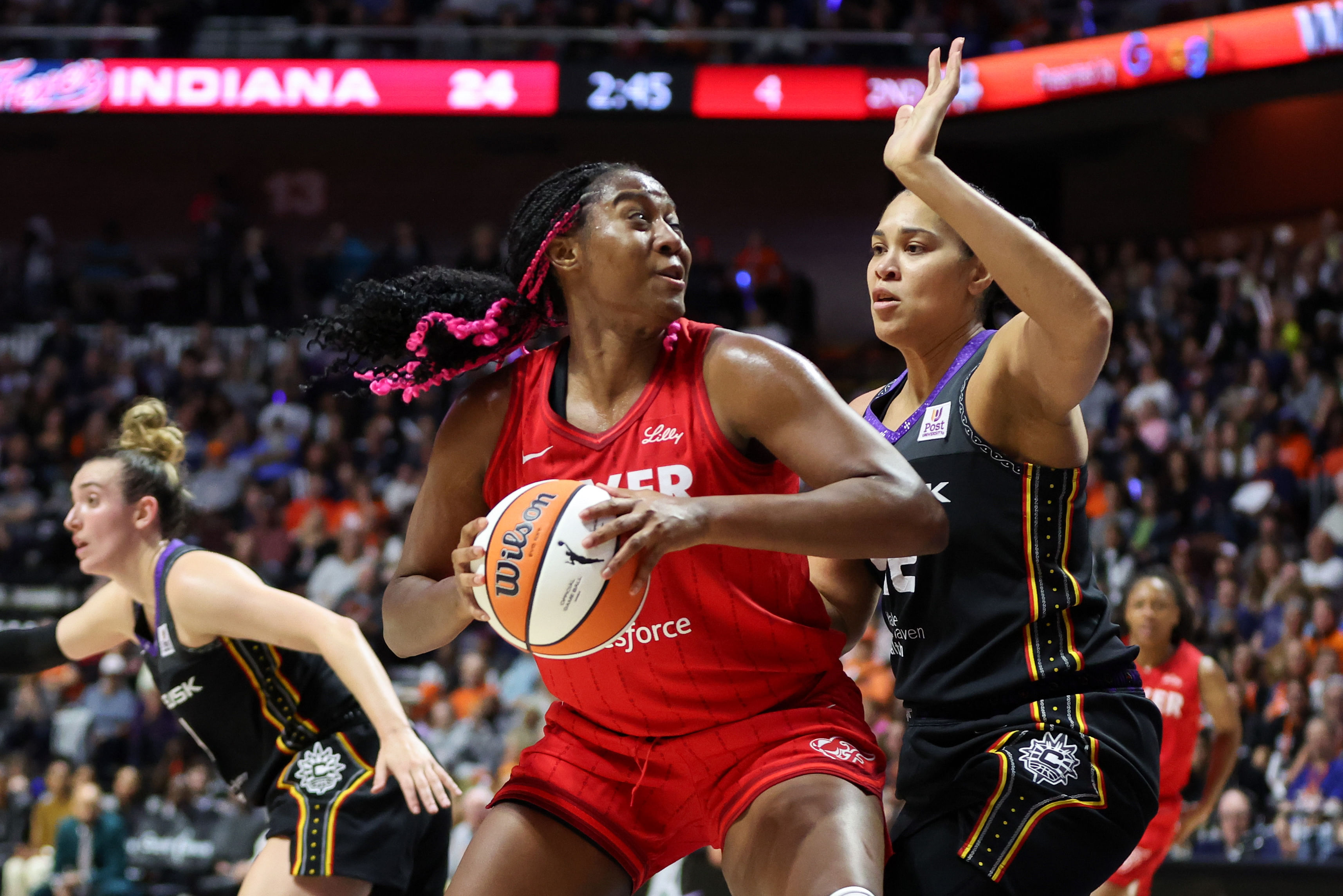 Sep 25, 2024; Uncasville, Connecticut, USA; Indiana Fever forward Aliyah Boston (7) drives to the basket during the first half against the Connecticut Sun during game two of the first round of the 2024 WNBA Playoffs at Mohegan Sun Arena. Mandatory Credit: Paul Rutherford-Imagn Images - Source: Imagn