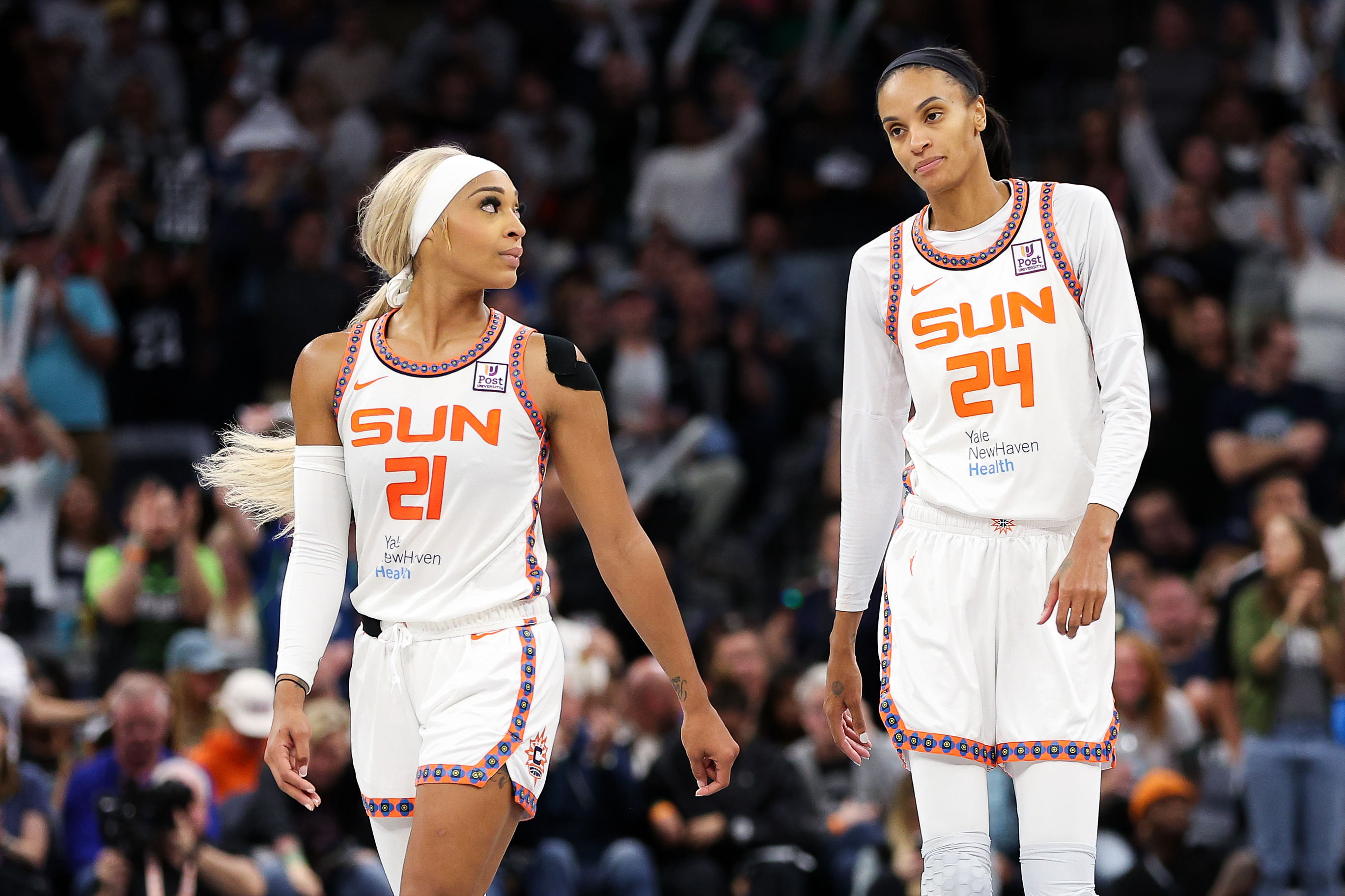 Oct 8, 2024; Minneapolis, Minnesota, USA; Connecticut Sun guard DiJonai Carrington (21) and forward DeWanna Bonner (24) look on during the second half of game five of the 2024 WNBA playoffs against the Minnesota Lynx at Target Center. Mandatory Credit: Matt Krohn-Imagn Images - Source: Imagn