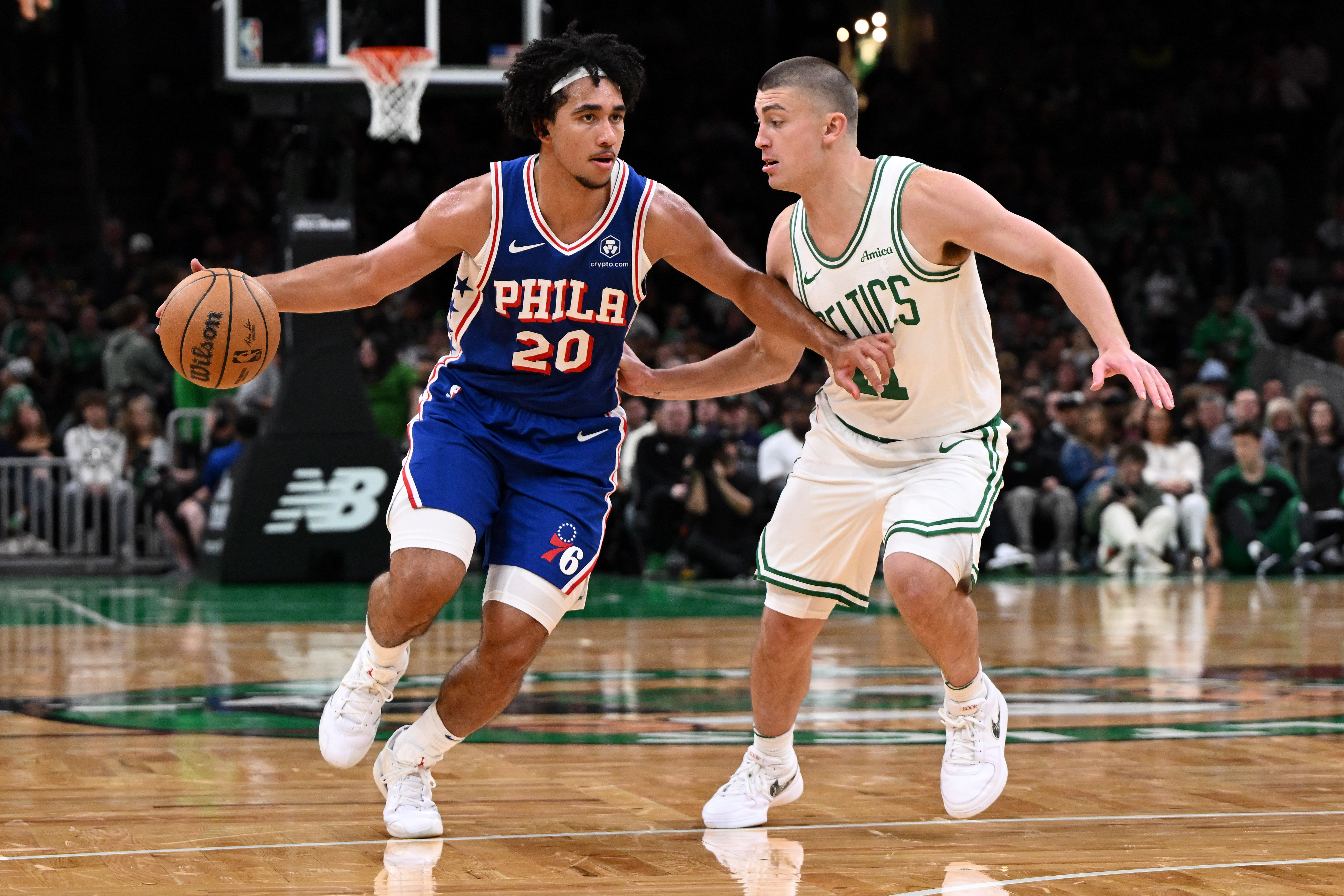 Philadelphia 76ers guard Jared McCain drives to the basket against Boston Celtics guard Payton Pritchard at the TD Garden. Photo Credit: Imagn