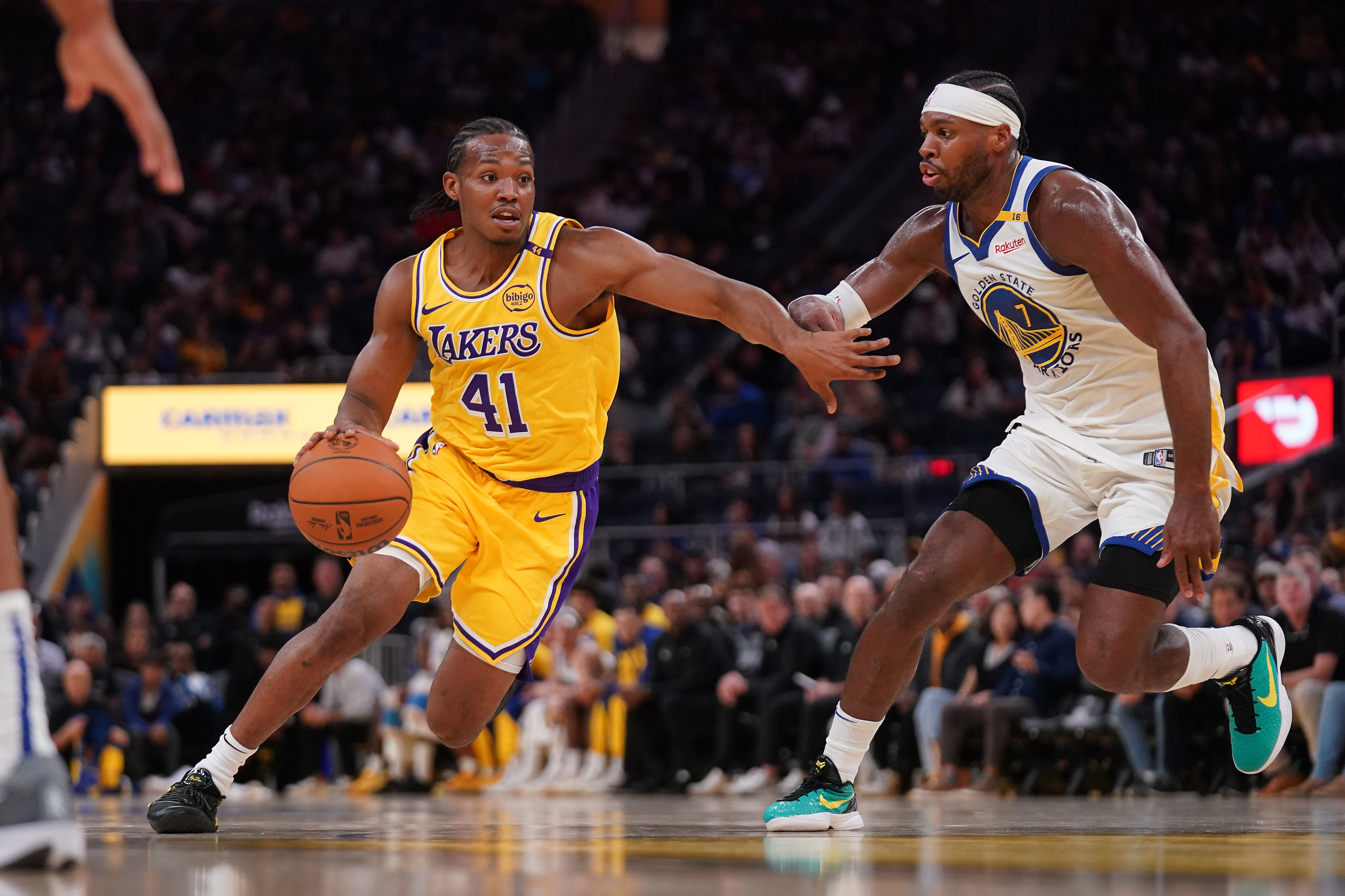 Los Angeles Lakers guard Quincy Olivari (41) dribbles past a Golden State Warriors player. (Credits: IMAGN)