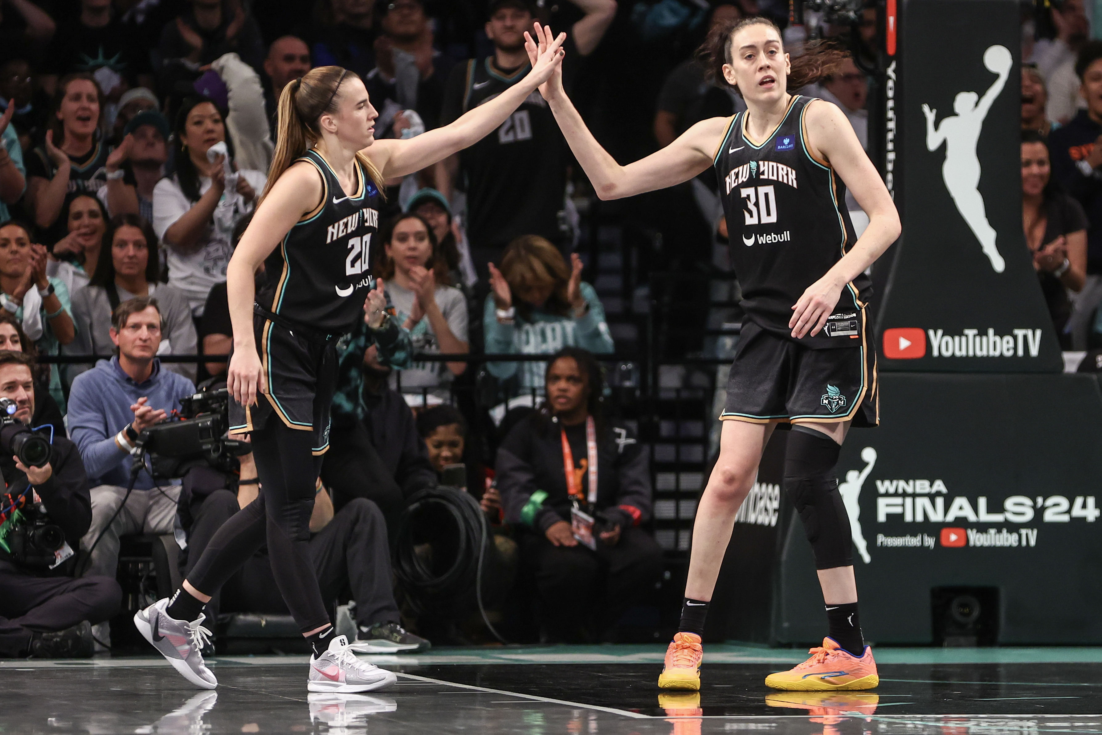 Oct 20, 2024; Brooklyn, New York, USA; New York Liberty guard Sabrina Ionescu (20) and forward Breanna Stewart (30) during game five of the 2024 NBA Finals at Barclays Center. Mandatory Credit: Wendell Cruz-Imagn Images - Source: Imagn