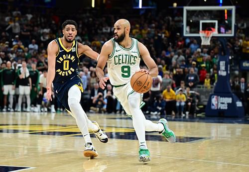 Boston Celtics guard Derrick White (9) drives the ball past Indiana Pacers guard Tyrese Haliburton (0) during overtime at Gainbridge Fieldhouse. Mandatory Credit: Marc Lebryk-Imagn Images