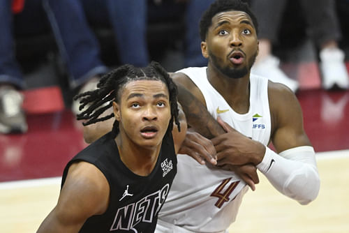 Brooklyn Nets forward Noah Clowney and Cleveland Cavaliers guard Donovan Mitchell look to rebound at Rocket Mortgage FieldHouse. Photo Credit: Imagn