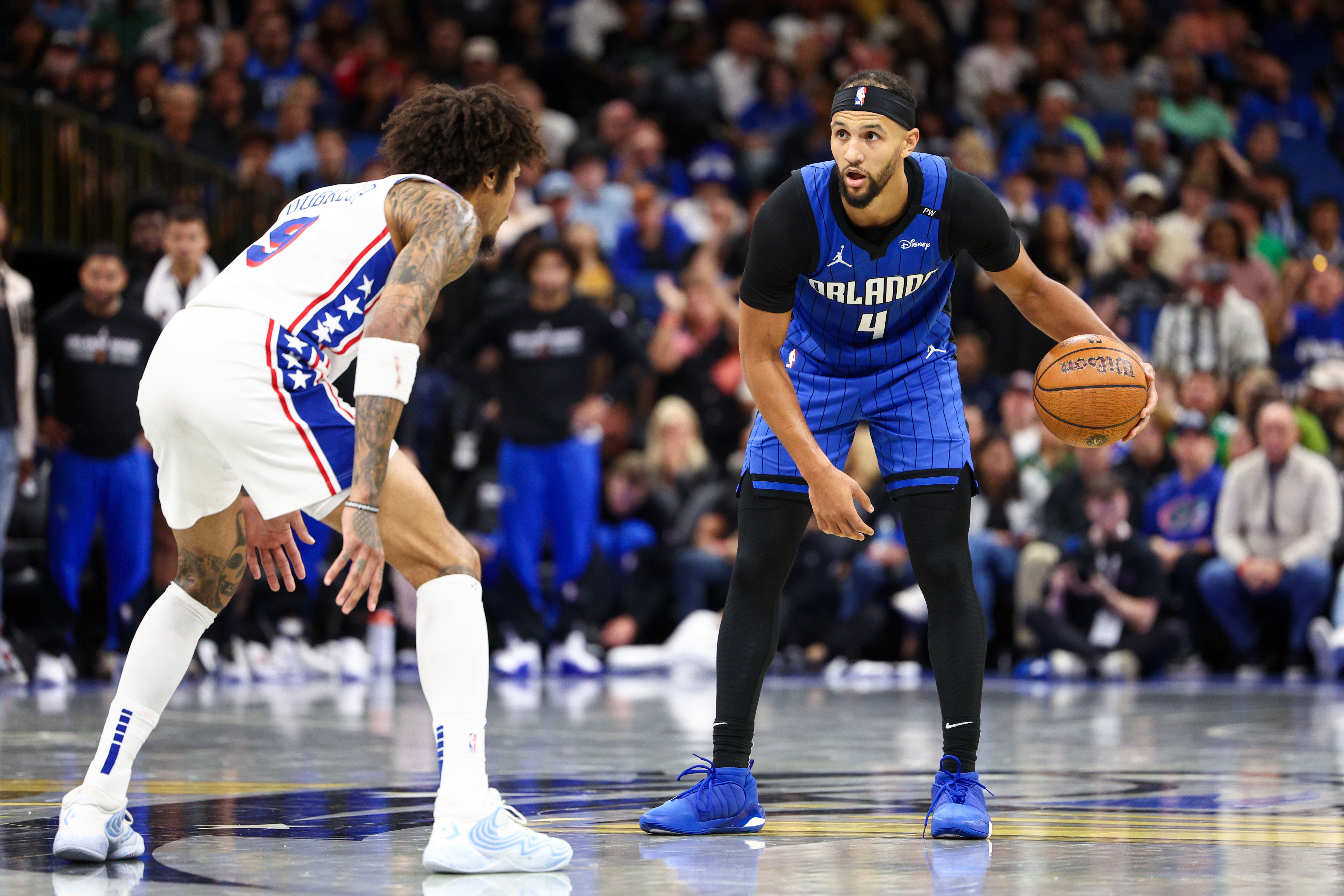 Orlando Magic guard Jalen Suggs is guarded by Philadelphia 76ers guard Kelly Oubre Jr. in the fourth quarter at Kia Center. Photo Credit: Imagn