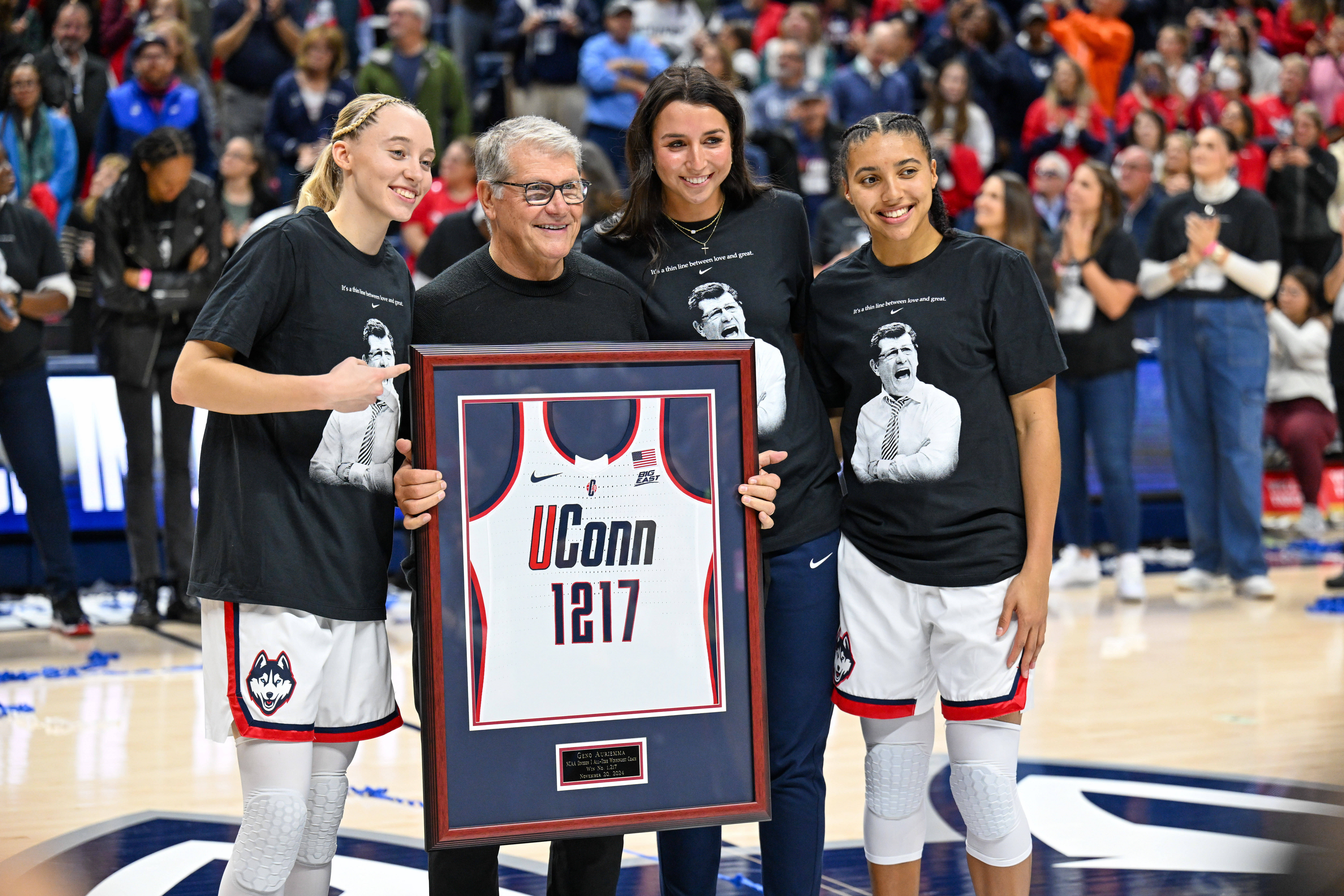 Connecticut Huskies guard Paige Bueckers (left) celebrates head coach Geno Auriemma setting the all time NCAA wins record with guard Azzi Fudd (35). Photo: Imagn