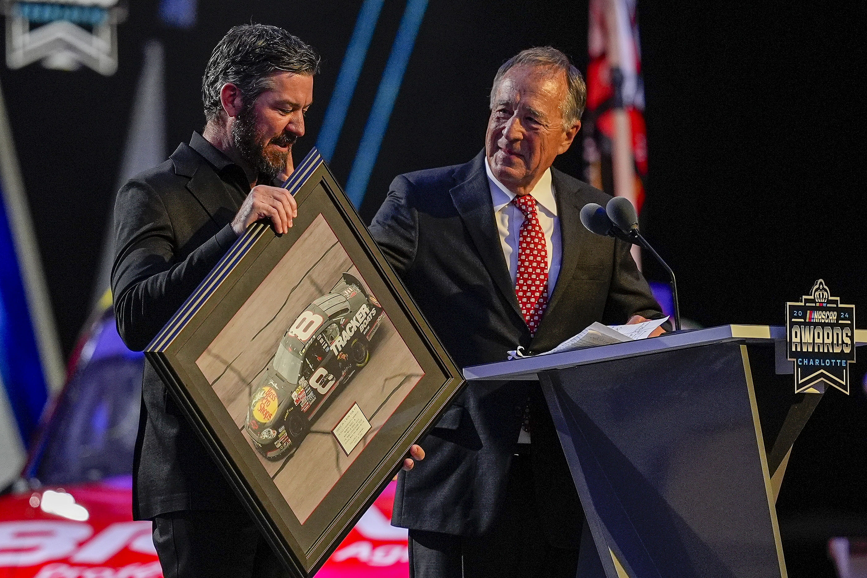 Bass Pro Shops President Johnny Morris presents a painting to retiring NASCAR Cup Series driver Martin Truex Jr. - Source: Imagn