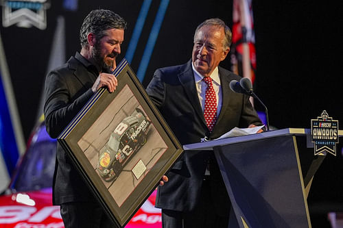 Bass Pro Shops President Johnny Morris presents a painting to retiring NASCAR Cup Series driver Martin Truex Jr. - Source: Imagn