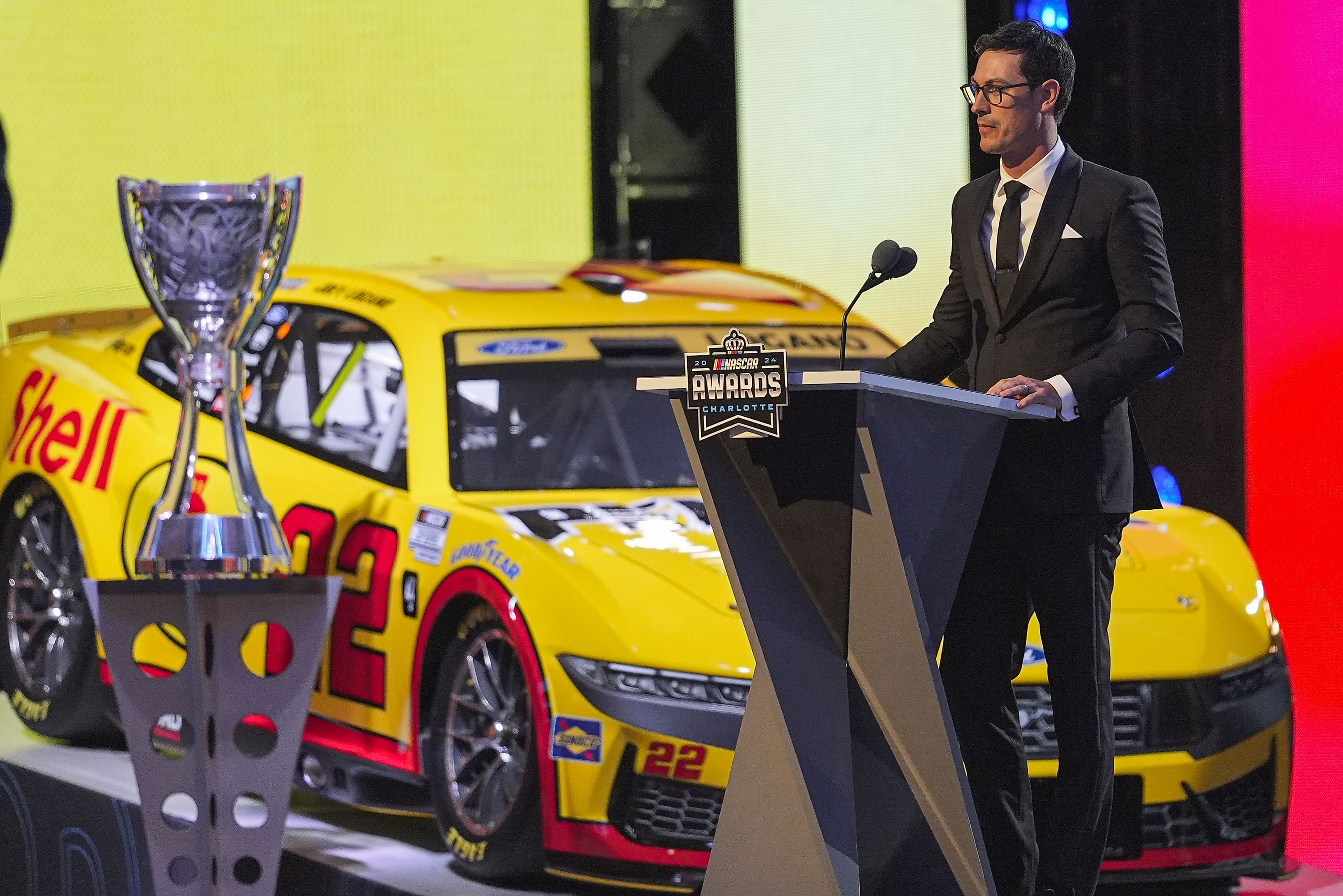 Joey Logano (22) next to his car and trophy - Source: Imagn