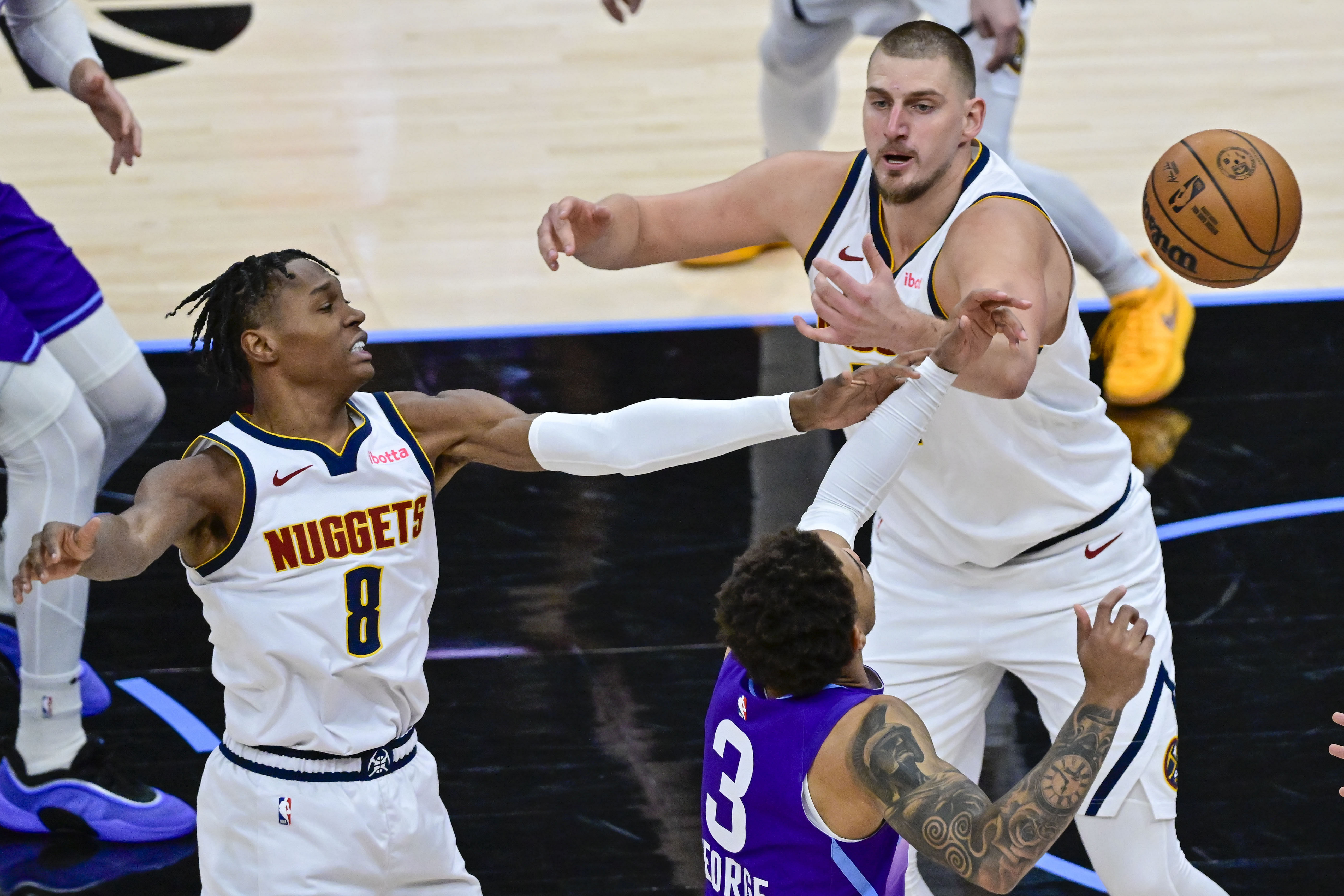 Utah Jazz guard Keyonte George gets the ball stripped by Denver Nuggets center Nikola Jokic and guard Peyton Watson at the Delta Center. Photo Credit: Imagn