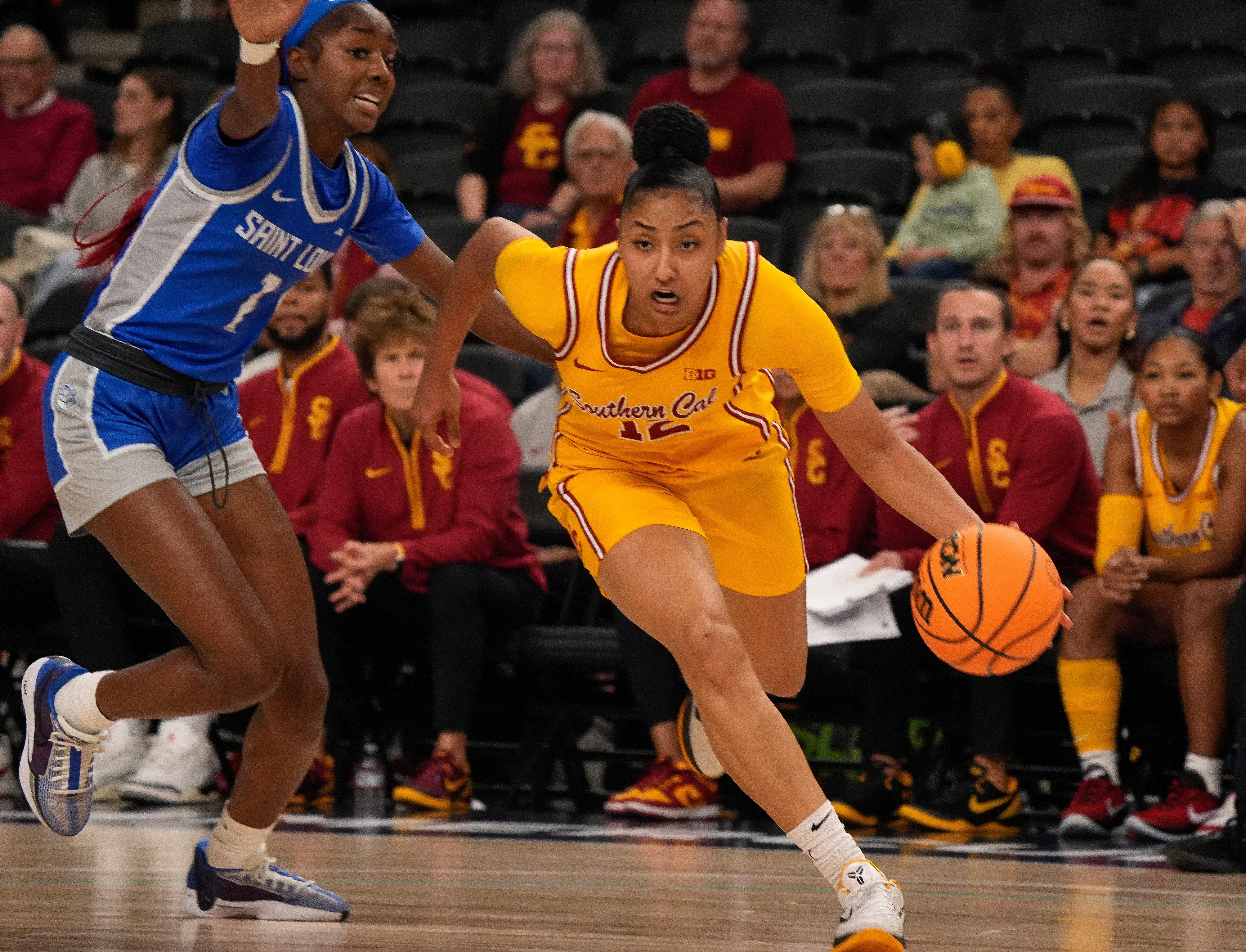 JuJu Watkins (#12) of the USC Trojans drives toward the basket while being defended by Hannah Wallace of St. Louis University during the 2024 Acrisure Women's Holiday Invitational. Photo: Imagn