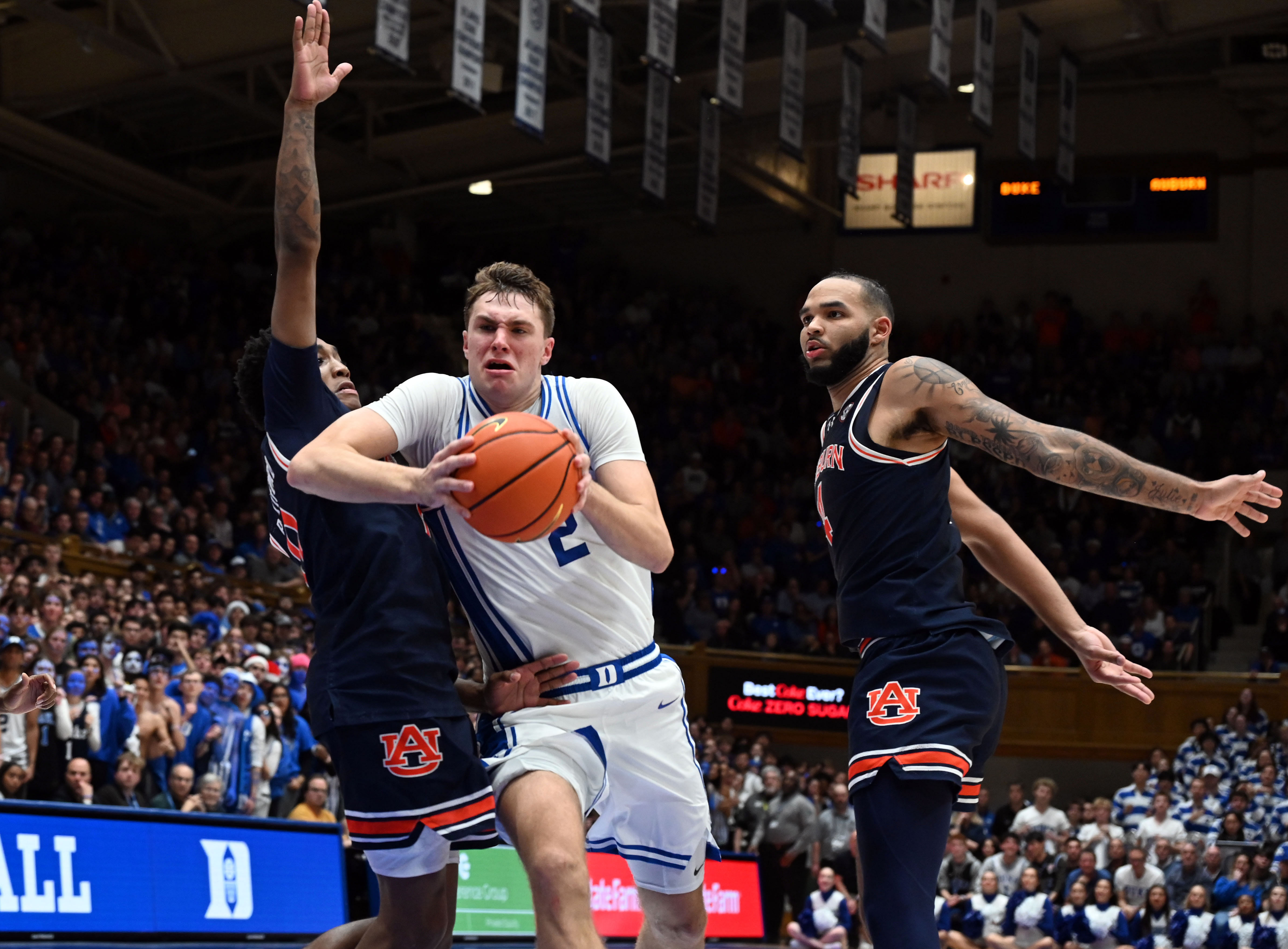 Duke Blue Devils forward Cooper Flagg (2) drives to the basket between Auburn Tigers guard Tahaad Pettiford (0) and center Johni Broome (4) during the second half of their NCAA game. Photo: Imagn