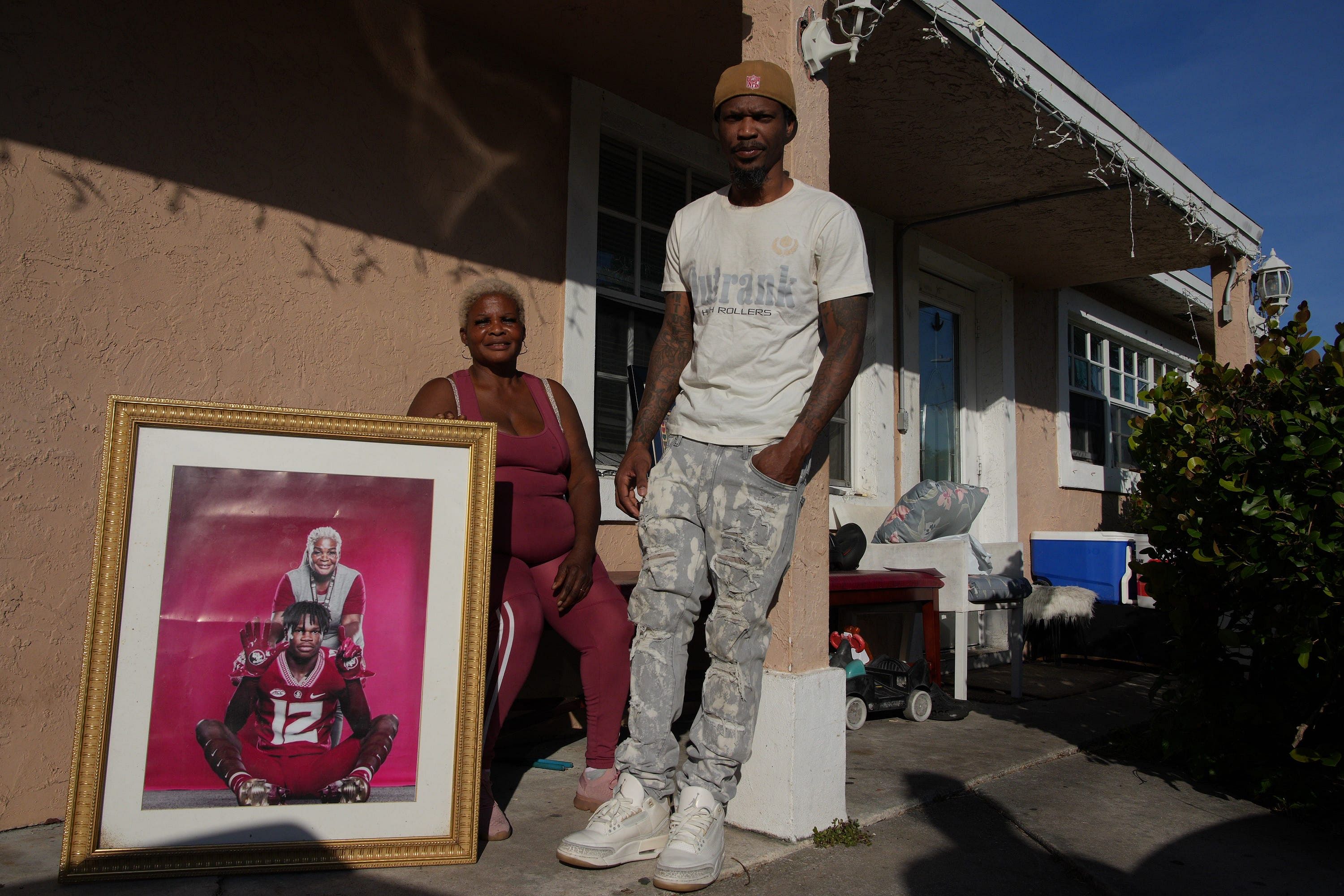 Shirley Hunter holds a photo of her grandson Travis Hunter Jr. with his father Travis Hunter, Sr. - Source: Imagn