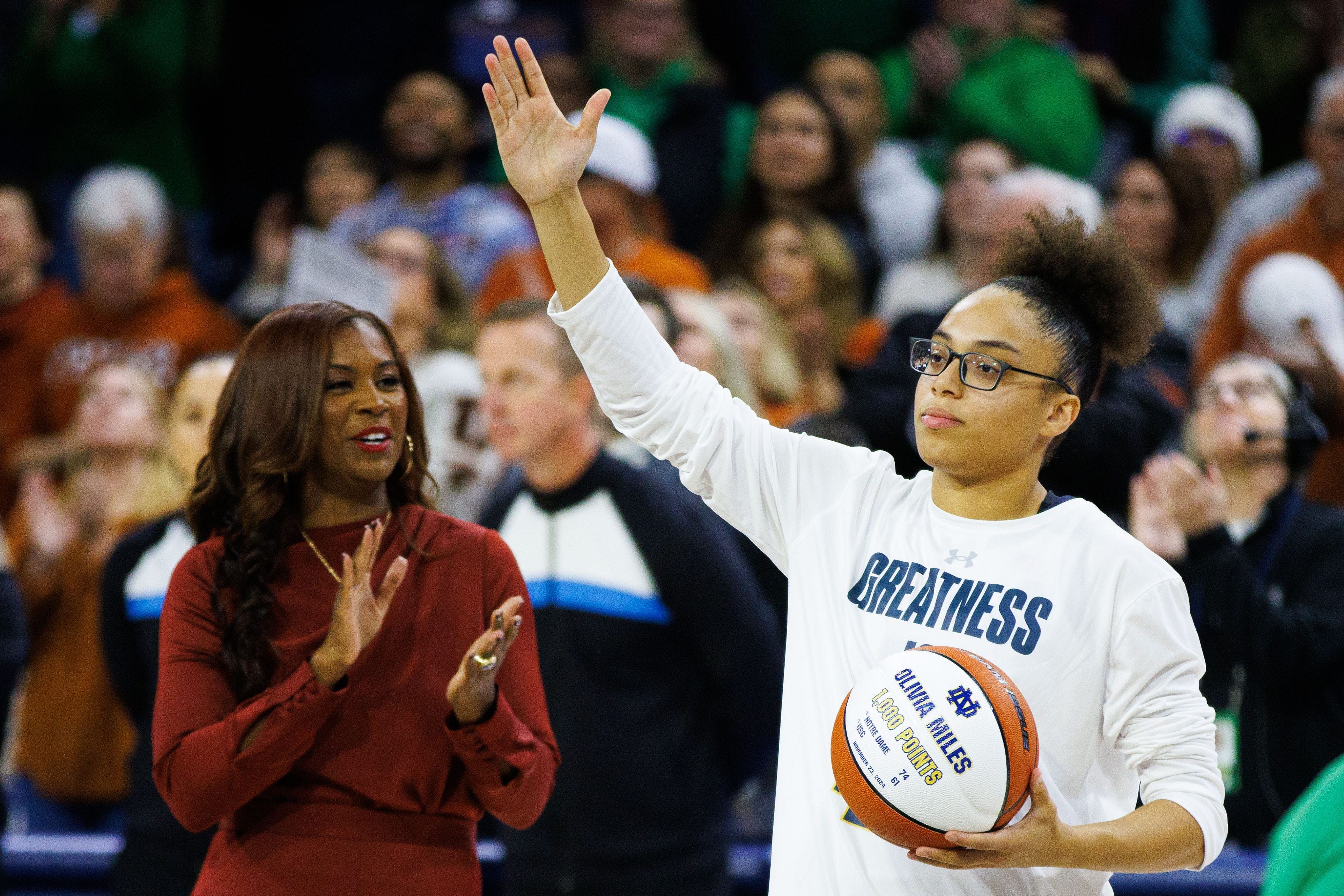 Olivia Miles receiving a commemorative ball for her 1000th college career point. - Source: Imagn