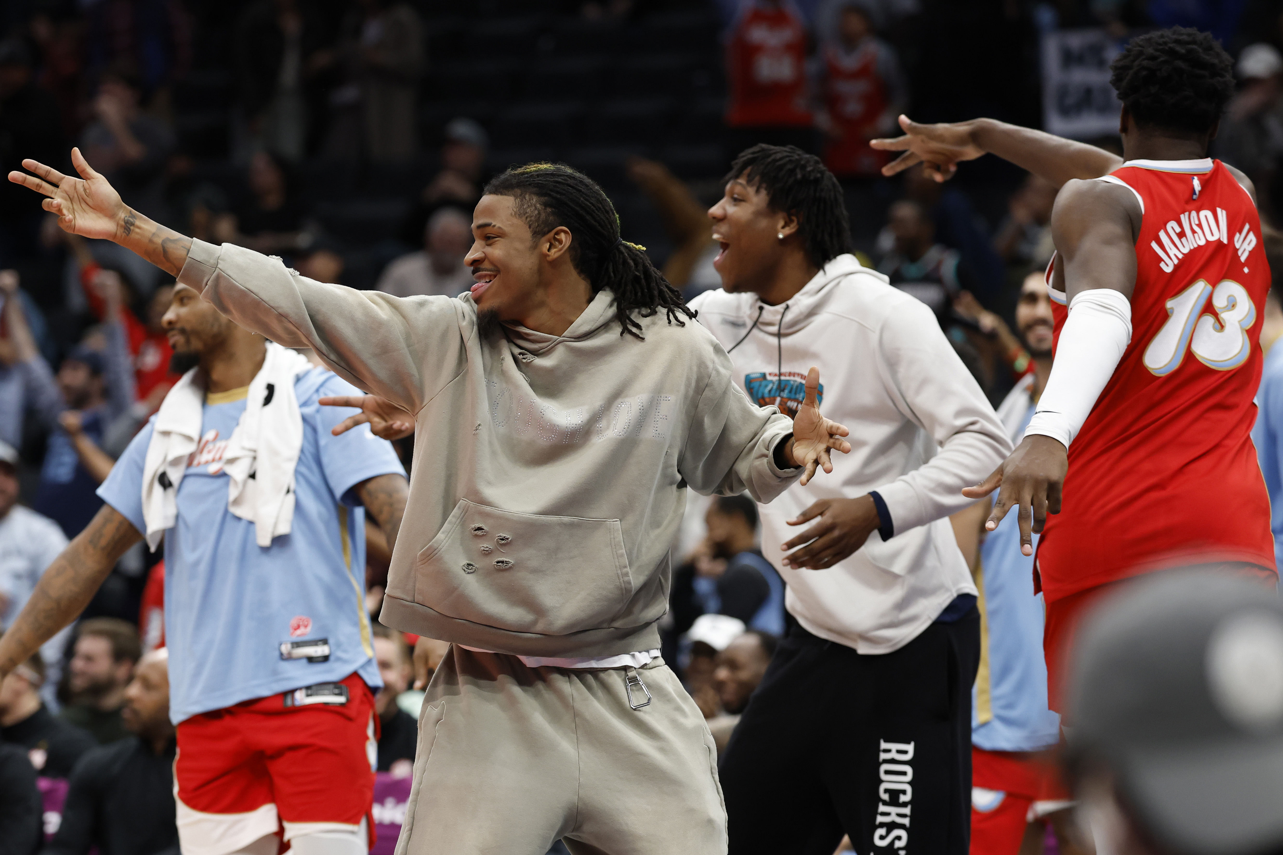 Memphis Grizzlies guard Ja Morant (M) celebrates with teammates after a 3-point field goal by Yuki Kawamura at Capital One Arena. Photo Credit: Imagn